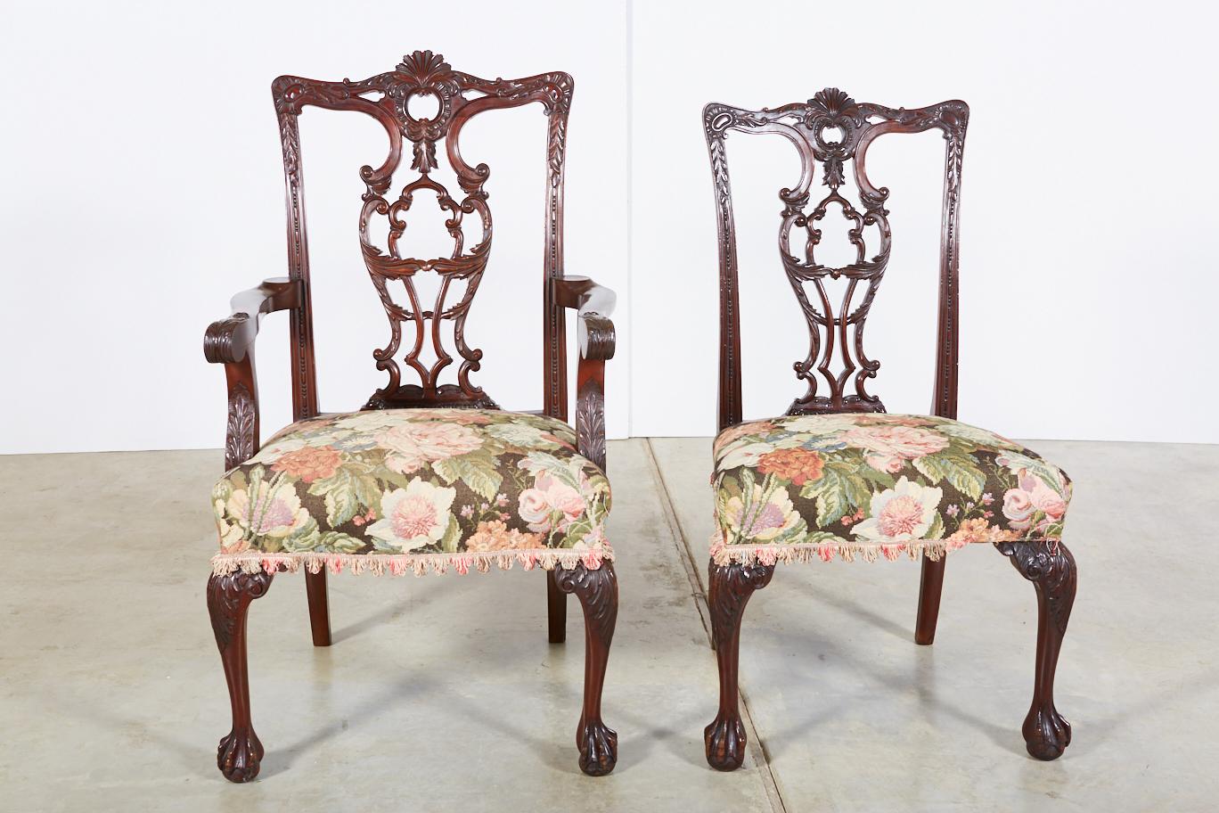 A set of 10 circa 1940 hand carved mahogany Chippendale style ribbon back dining chairs consisting of 2 armchairs and 8 side chairs. Beautiful dark patina. The armchairs' measurements are as follows: overall height 44