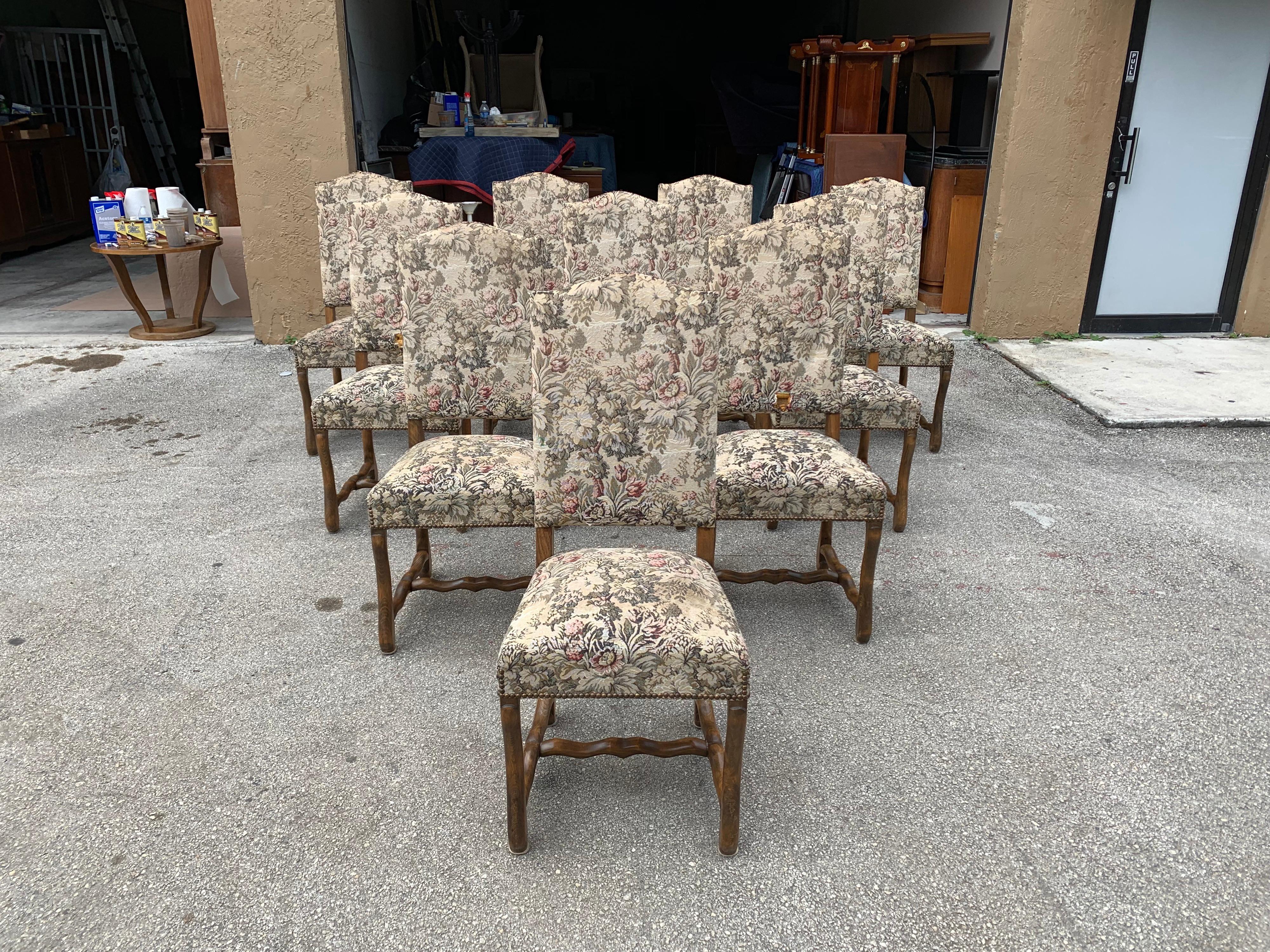 Fine set of 10 Louis XIII style Os de mouton dining chairs with chapeau de gendarme backs, circa 1900s century. Vintage fabric upholstery with nailheads, solid walnut chair frames are in excellent condition. From Lyon. Fabric recommended to be