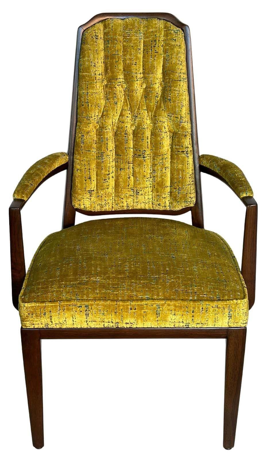 Vintage set of ten chairs by Monteverdi Young, made in USA, c. 1950's. The set consists of eight side chairs and two armchairs, each being newly upholstered with a unique soft green/mustard fabric and refinished walnut chair
