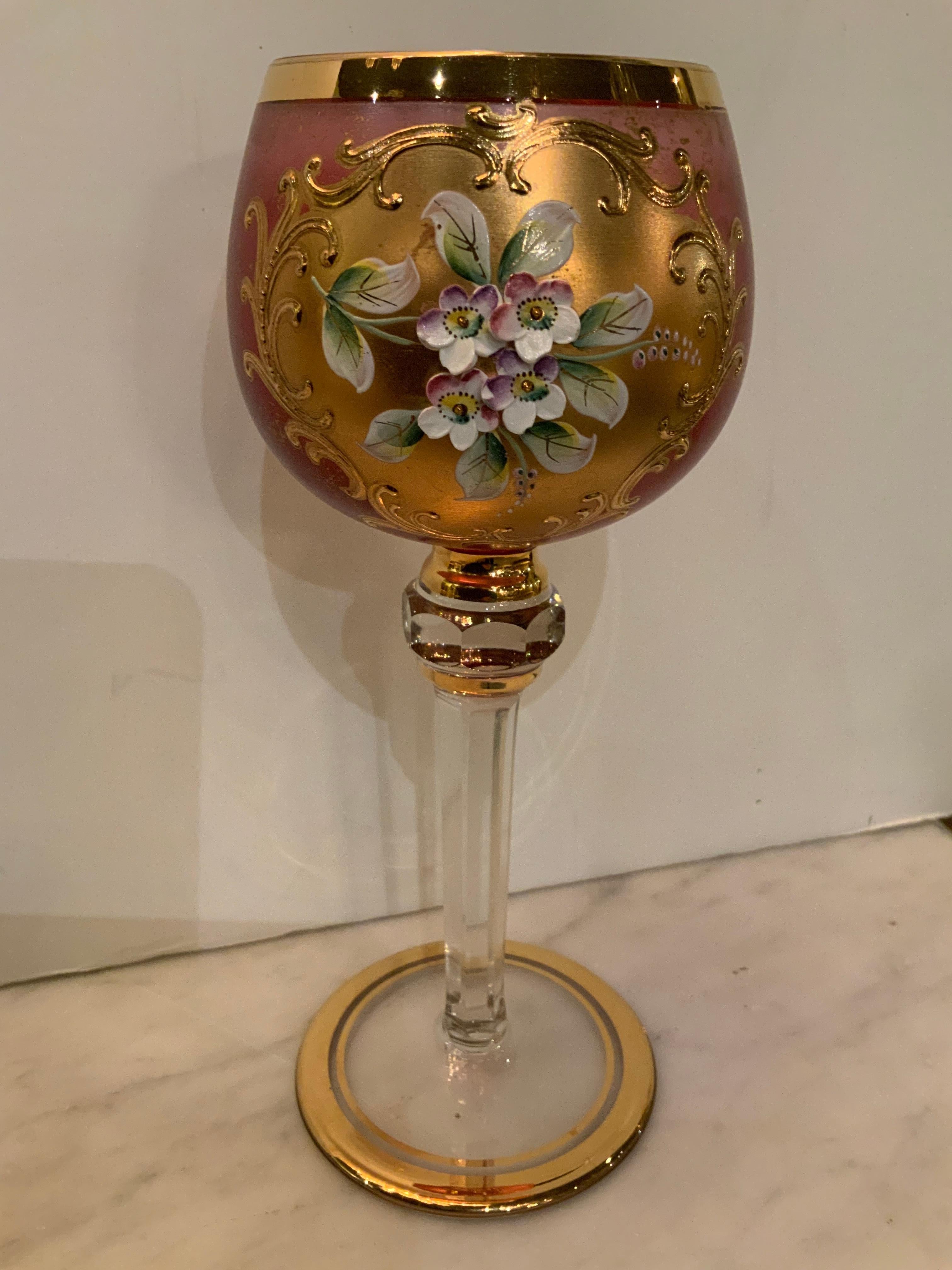 This set of wine glasses is exquisite because the color is very
Special in a light rose colored hue with a gold cameo in a brilliant 
Gold which has a spray of hand painted flowers in white on the front
Of each glass. They are in great condition