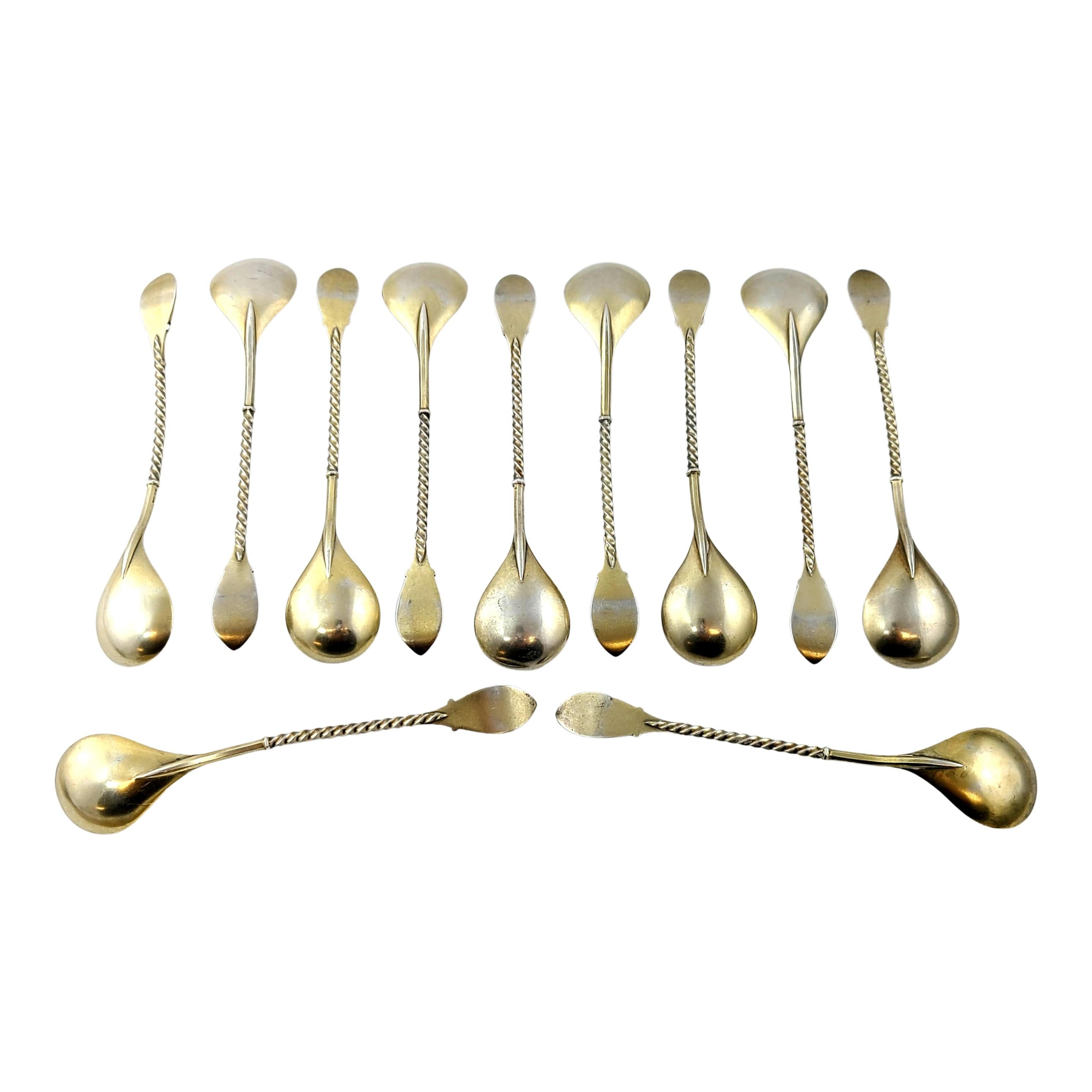 Set of 11 gold gilt over sterling silver and enamel demitasse spoons, by David Andersen Norway.

Gold gilt over sterling silver spoons with a teardrop shaped bowl, beautifully enameled in a blue and white floral design atop each twist design