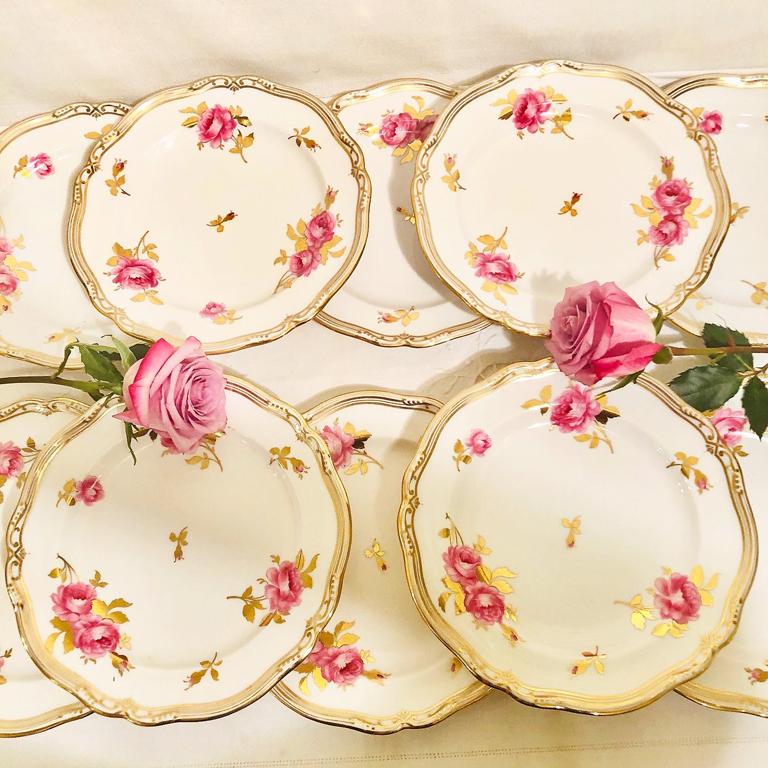 We are offering this set of eleven Spode Copelands dessert plates made exclusively for Tiffany & Co., New York. They have hand painted pink roses with gold stems and leaves on a white base color with gadrooned borders. They would be perfect for your