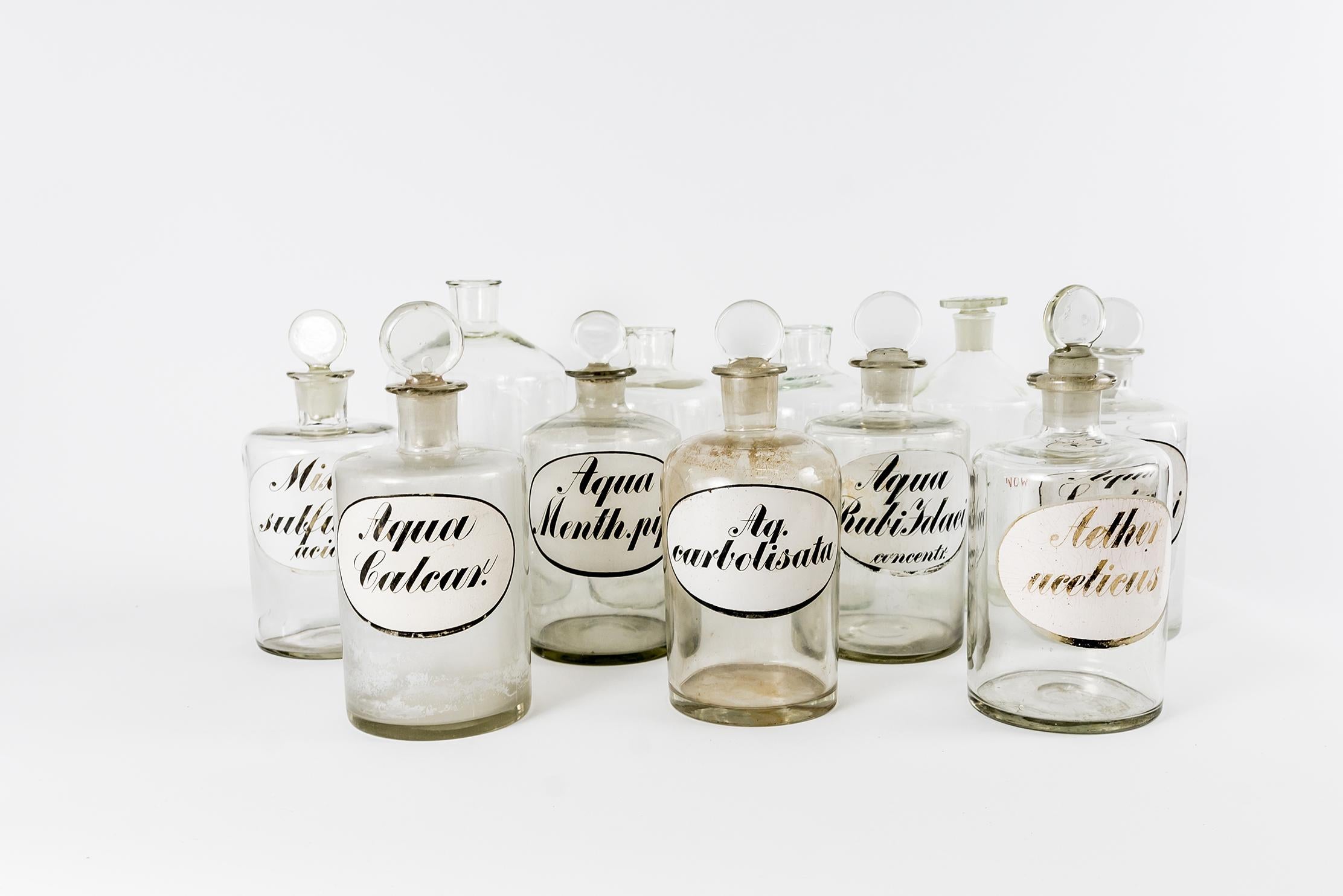 Set Of 11 Glass Pharmacy Bottles
The set:
21cm x 7pcs
All 7 Bottles have round glass stoppers, and inscriptions. one of the bottles is slightly cracked, 1920s, Germany
23cm x 3pcs (one with glass stopper)
25cm x 1pcs
All 4 Bottles are from the
