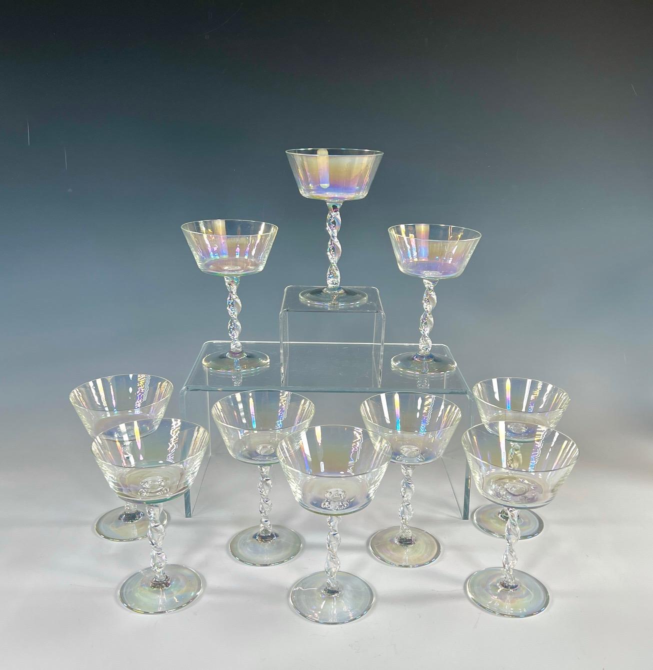 This amazing set of 11 hand blown crystal champagne coupes are sure to please, whether filled with you favorite champagne or cocktail or just sitting on a shelf catching the light. The lustrous rainbow-like effect is a showstopper with the subtle