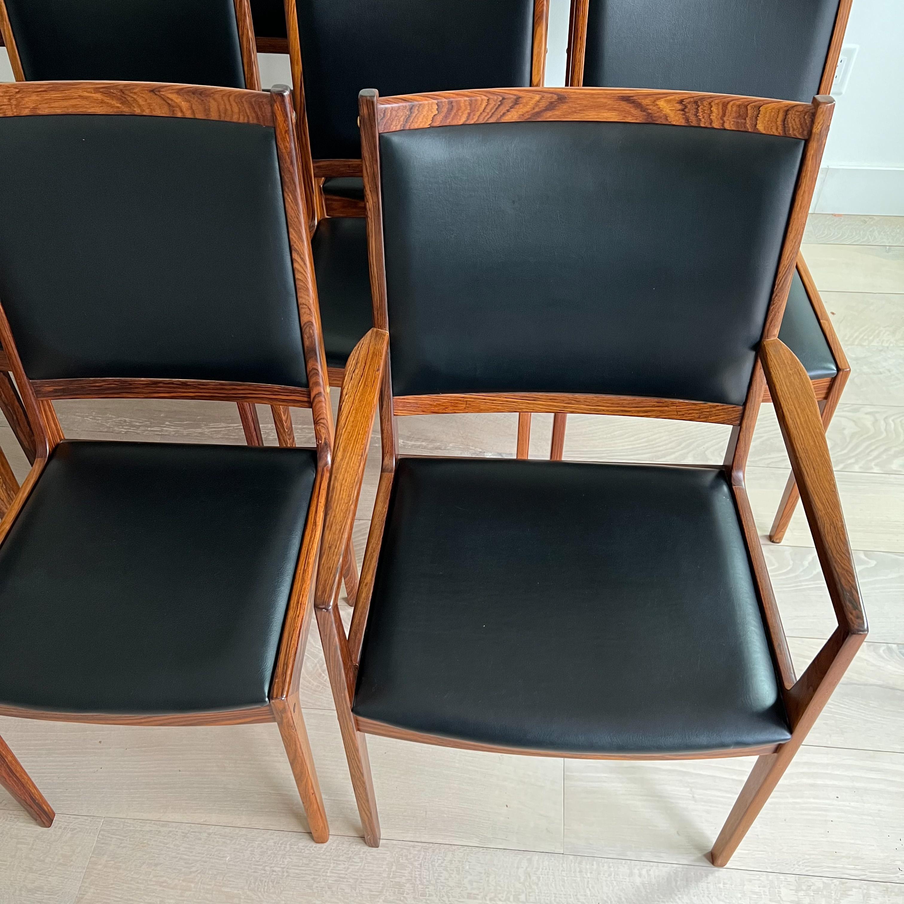 Ensemble de 11 chaises de salle à manger en bois de rose à haut dossier, difficiles à trouver, conçues par Kofod Larsen. Deux fauteuils, 9 sans bras. Le Naugahyde noir est en bon état général. Quelques petites entailles, sinon de légères