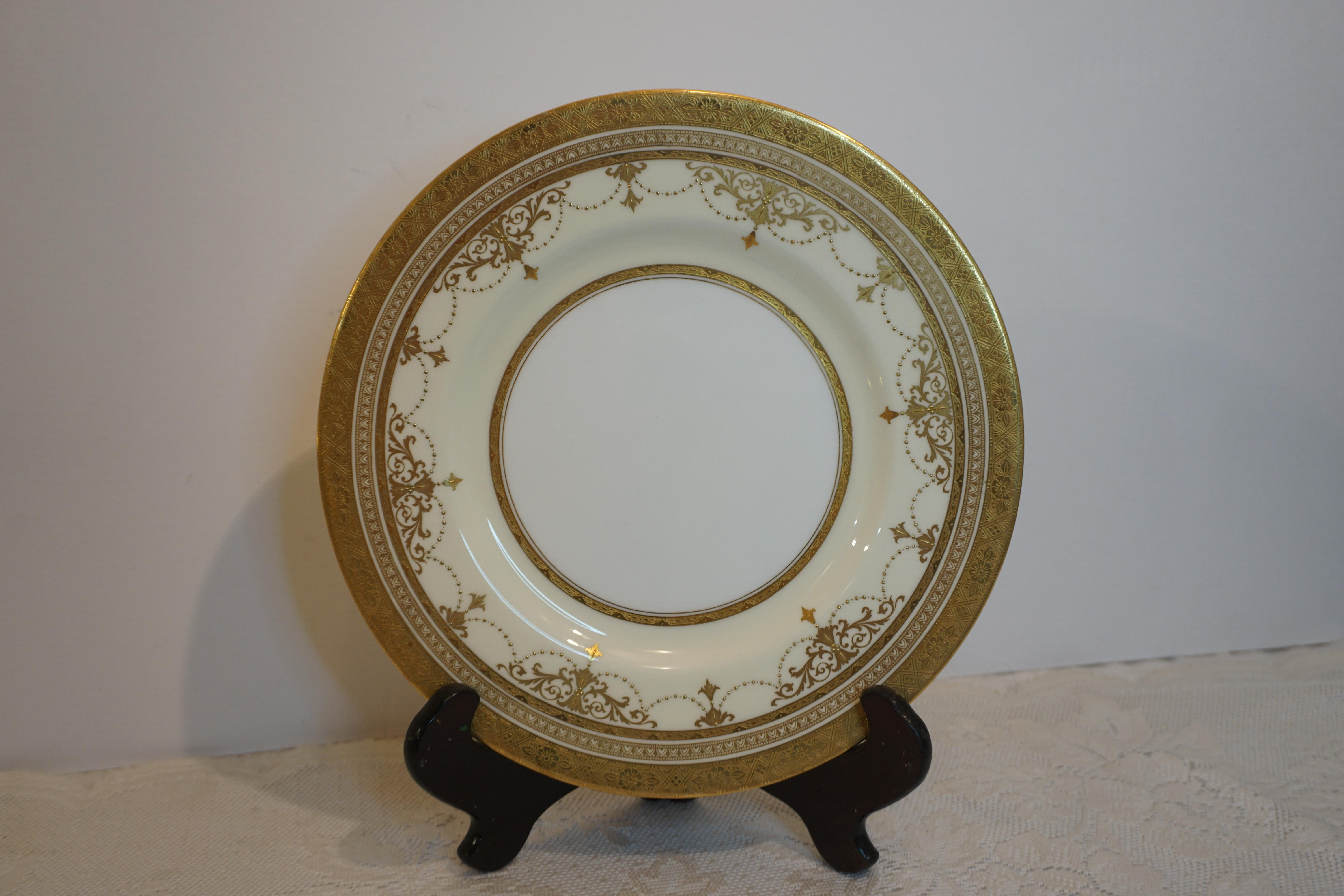 Embossed Set of 11 Minton Dinner Plates with Raised Gold Jeweled Garlands and Gold Border For Sale