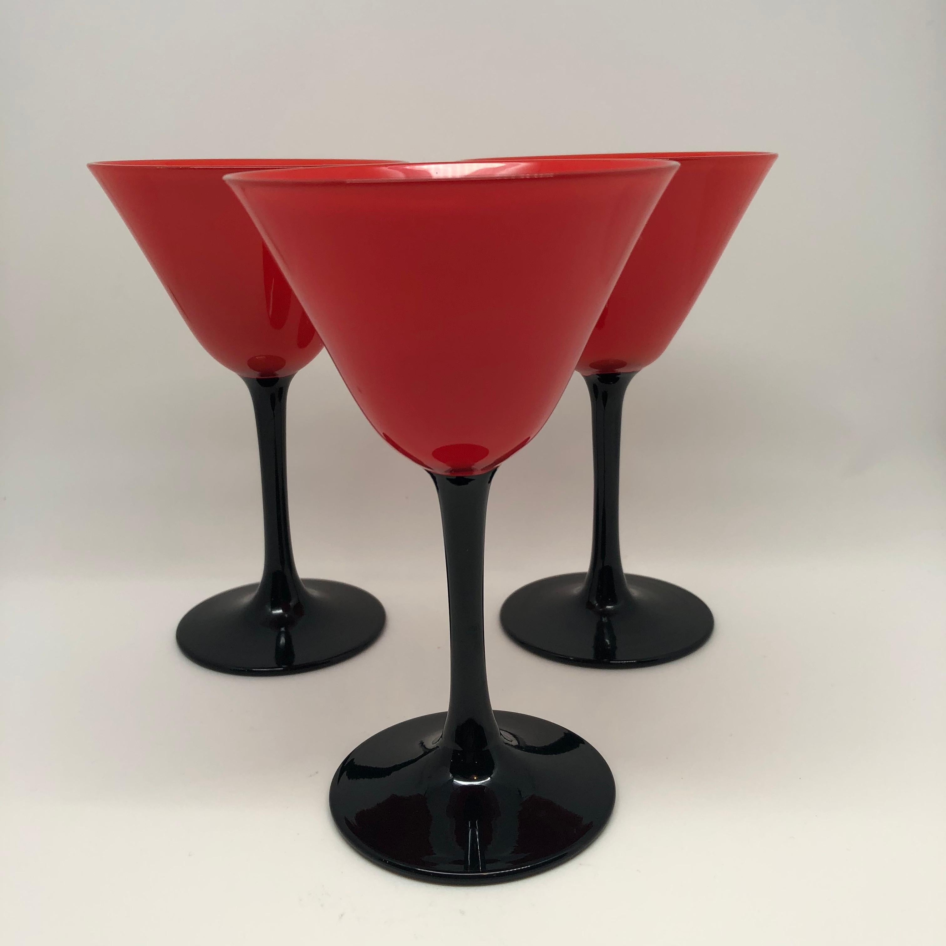 This is a fabulous set of eleven Pairpoint Art Deco stemware glasses with a striking color combination of red tops and black stems. This rare set is from the 1920s. They are 5 1/8 inches tall. Price for set is $895.00.