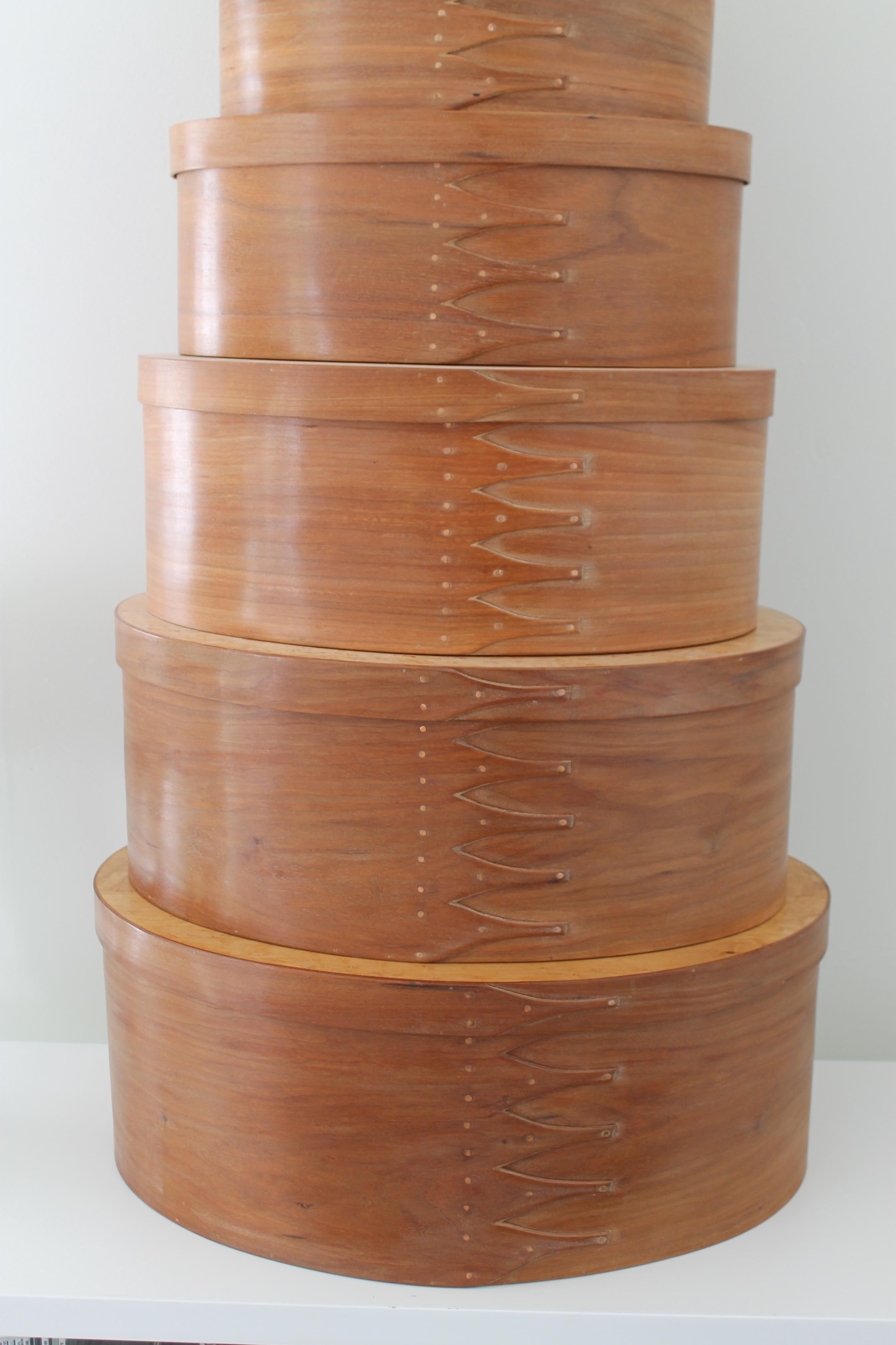 Set of eleven stacking handmade Shaker boxes signed James Lynch for the Dahl Company out of Portland, Maine circa 2001. These were purchased new in 2001 and were never taken out of their original wrapping until recently. Absolutely mint and so