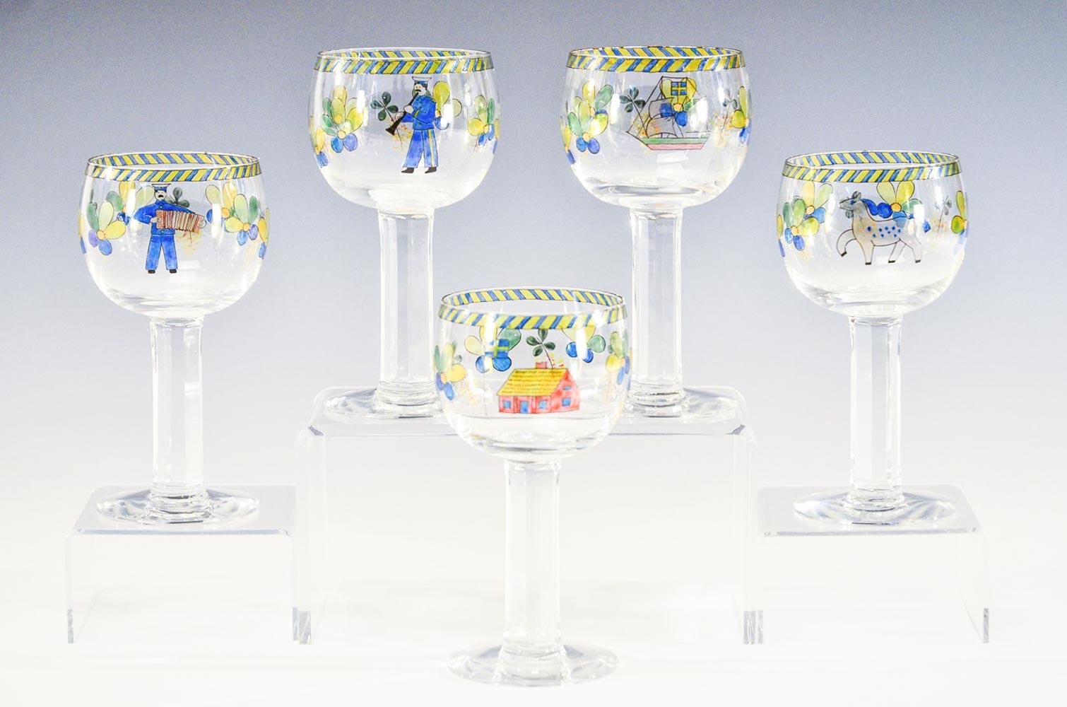 A wonderful set of 11 large goblets, made by Orrefors with panel cut and polished columnar stems. Each signed glass is individually hand painted with whimsical and playful 
