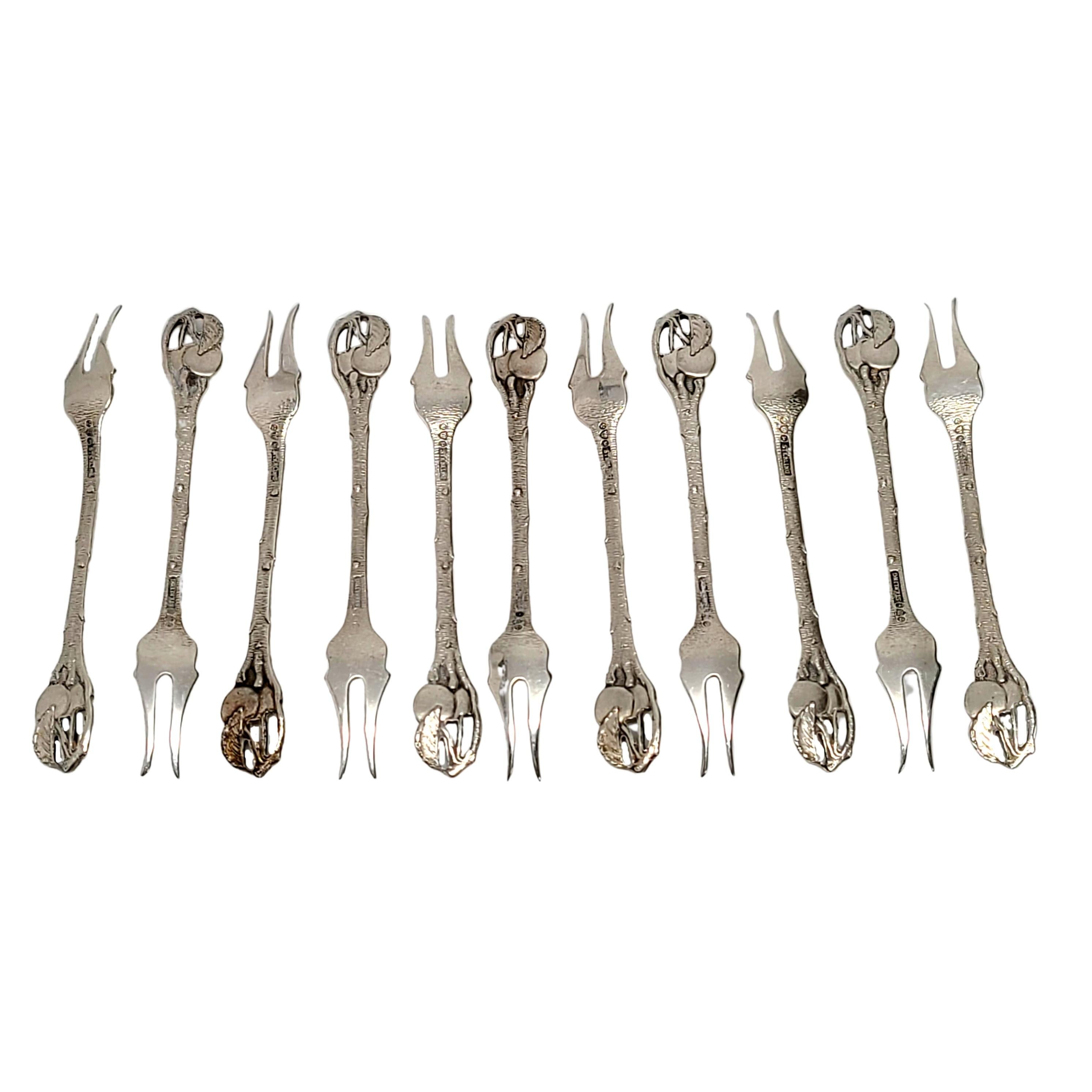 Set of 11 antique sterling silver cherry forks by Watson Co.

No monogram.

Beautiful set of small forks with cherries on the top of the handles, two curved tines.

Measures approx 3