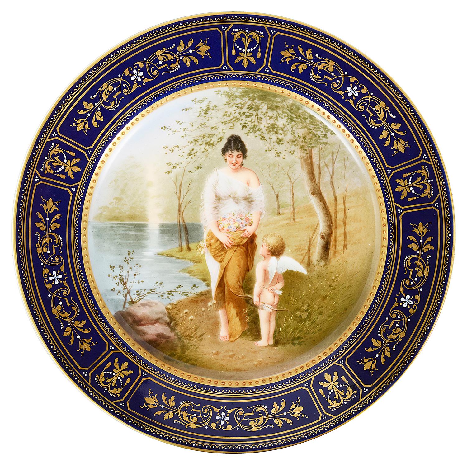 A wonderful collection of twelve late 19th century Vienna porcelain plates, each depicting classical and romantic scenes of women, some with children or cherubs. Having cobalt blue boarders with gilded decoration.
Blue Bee hive marking to the