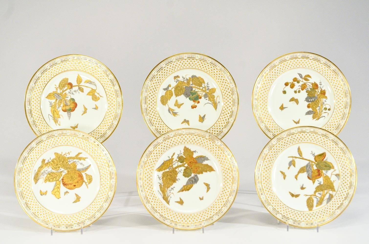 This set of 12 dessert plates is a fabulous example of the artistry of the Aesthetic Movement. Each plate is hand-painted in shades of raised paste gold, silver, green and apricot gilt and framed in a intricate latticework border trimmed in