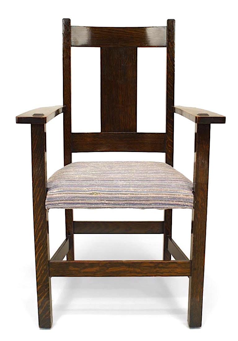 Set of 12 American Mission oak dining arm chairs with squared back above a beige upholstered seat on legs joined by box stretchers (branded: Limbert)
