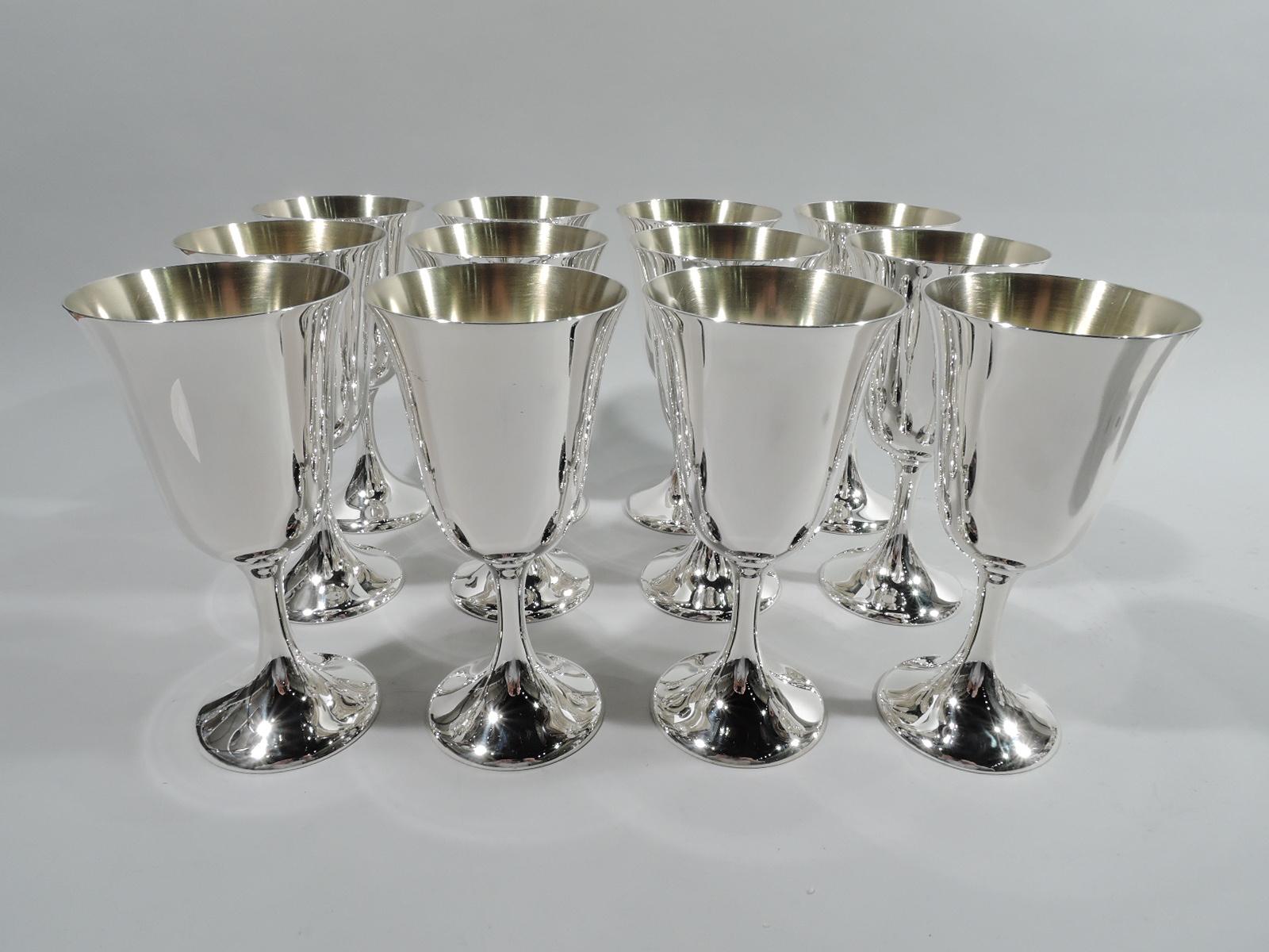 Set of 12 modern sterling silver goblets. Made by Manchester in Providence. Each: Tapering bowl with gently flared rim, and cylindrical stem flowing into raised foot. Bowl interior gilt. Fully marked including maker’s stamp and no. 808. Total