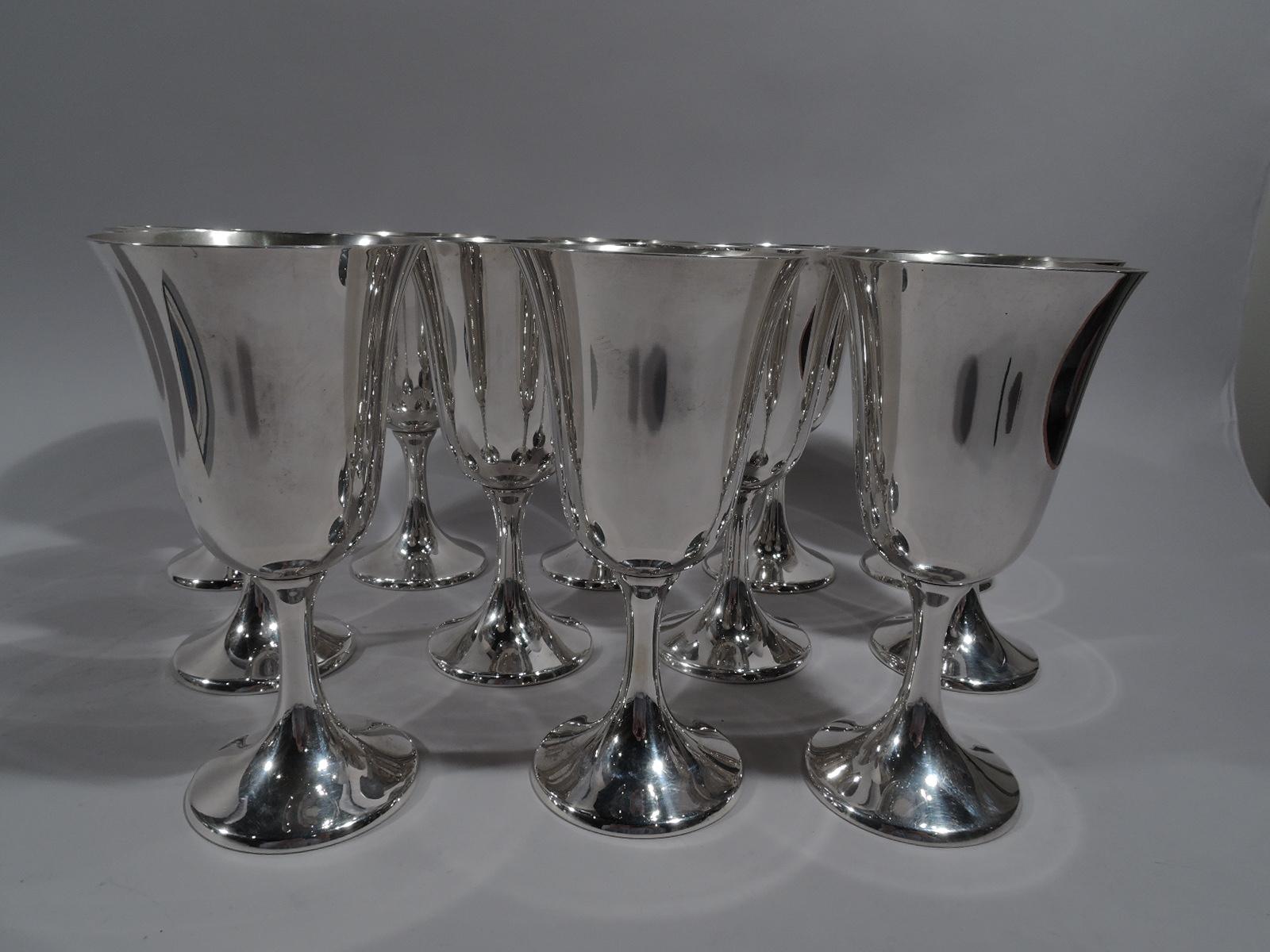 Set of 12 American modern sterling silver goblets. Made by Manchester in Providence. Each: Tall and flared bowl on spool stem flowing into raised foot. Fully marked and numbered 808. Total weight: 60 troy ounces.