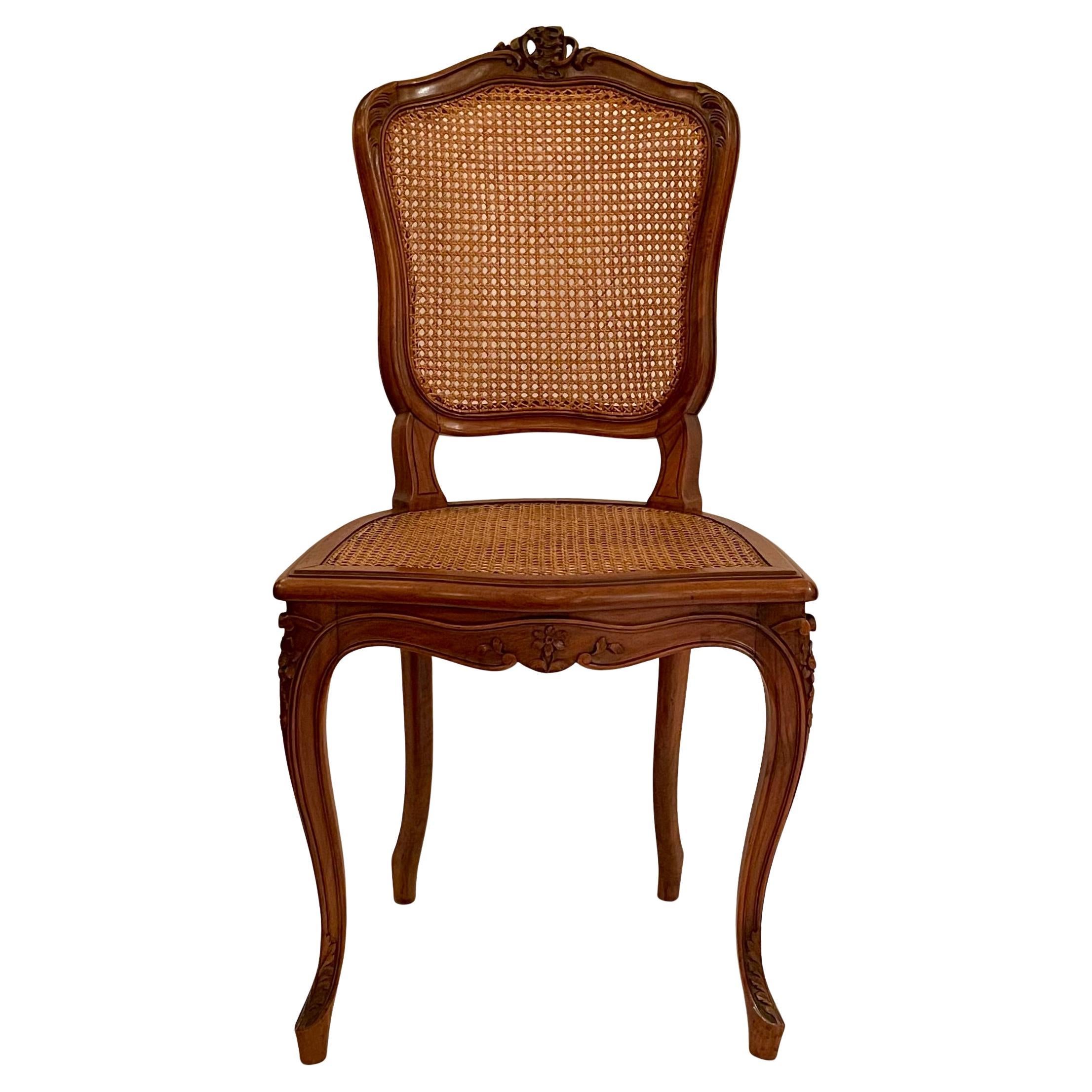 Set of 12 Antique 19th Century French Carved Walnut Dining Chairs with Cane Backs and Cane Seats.