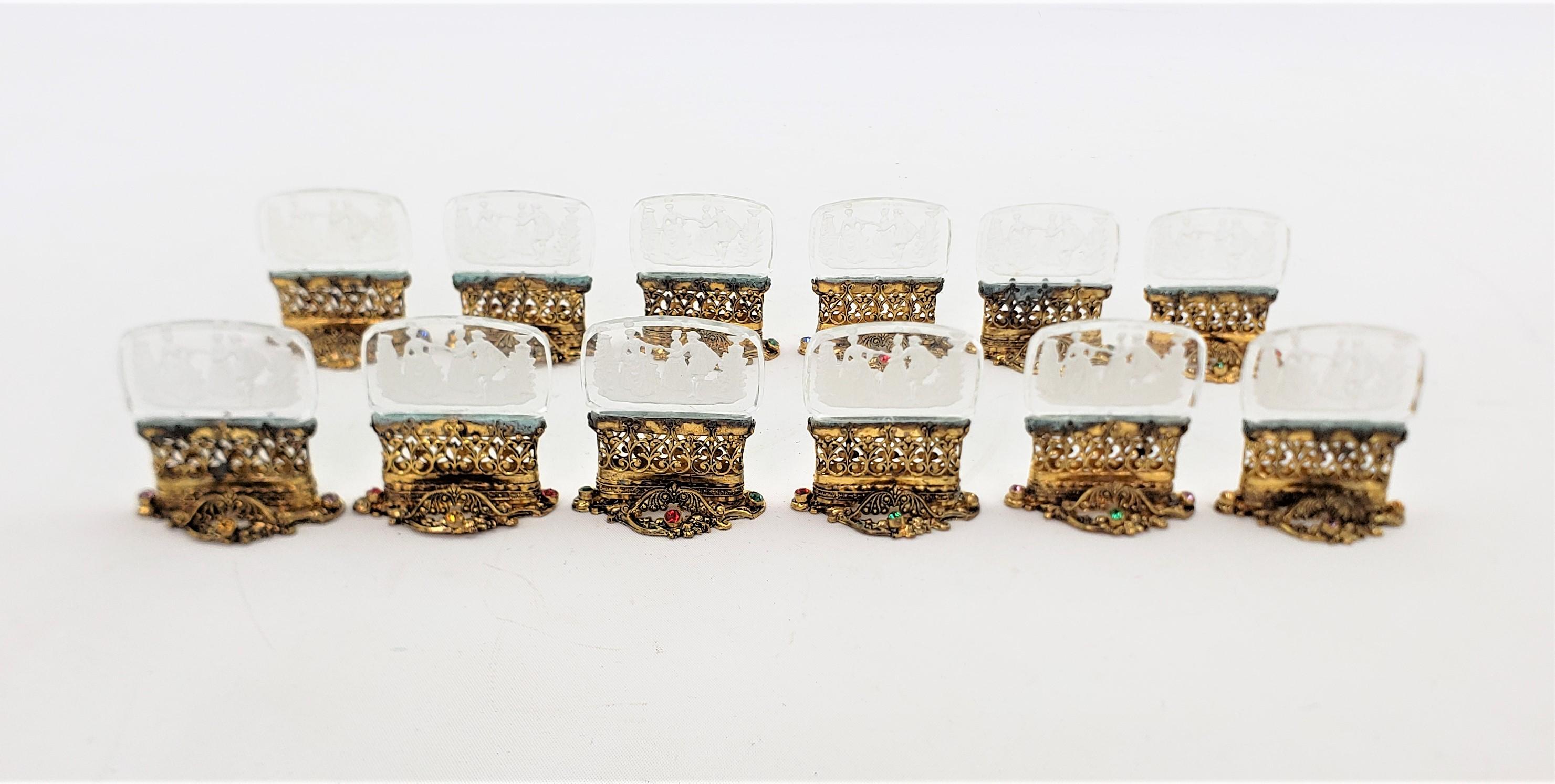 These antique place card or menu holders show no maker's mark, but are presumed to have originated from the Czech Republic and date to approximately 1920 and done in a Renaissance Revival style. The holders are done in a cast white metal with