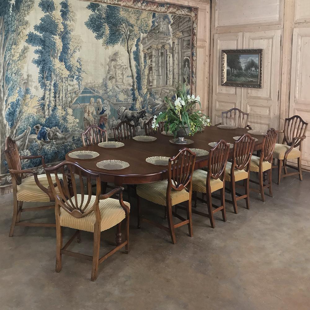 Set of 12 antique English Sheraton dining chairs includes 4 armchairs and were handcrafted from fine walnut, and feature the Classic shield backs and generous seats that will provide comfortable elegance for your dining enjoyment,
circa early