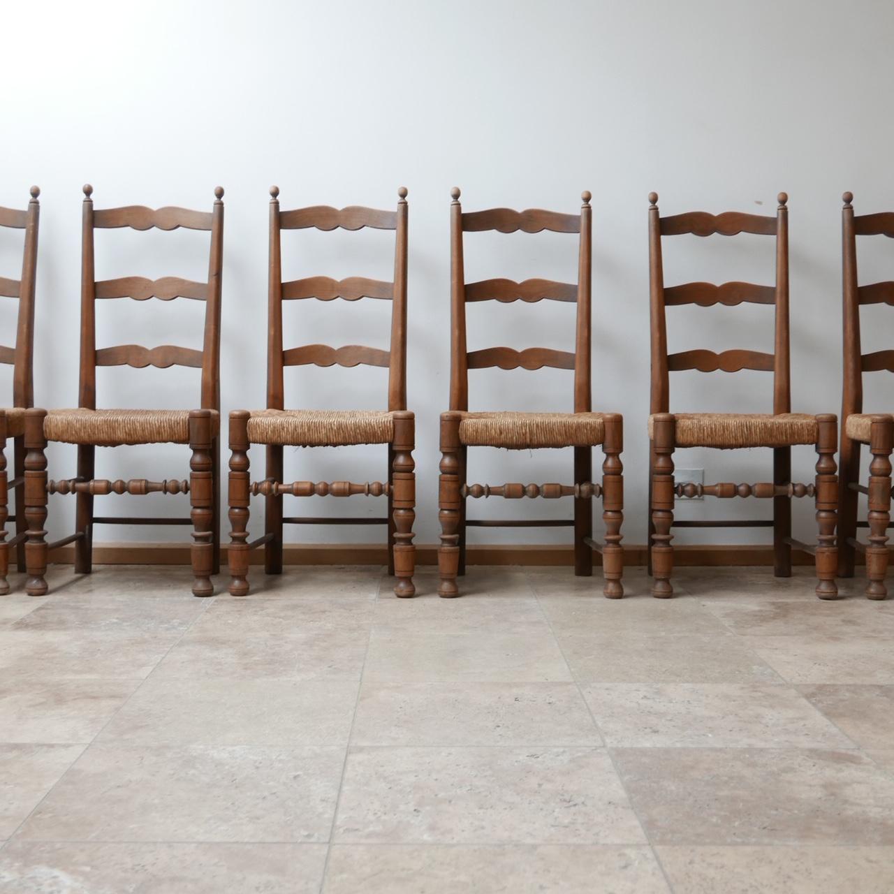 Antique French farmhouse dining chairs. 

Rare set of 12. 

Rush seats in good condition,

France, c1930s. 

Dimensions: 44 W x 42 D x 47 seat height x 108 total height in cm.

 