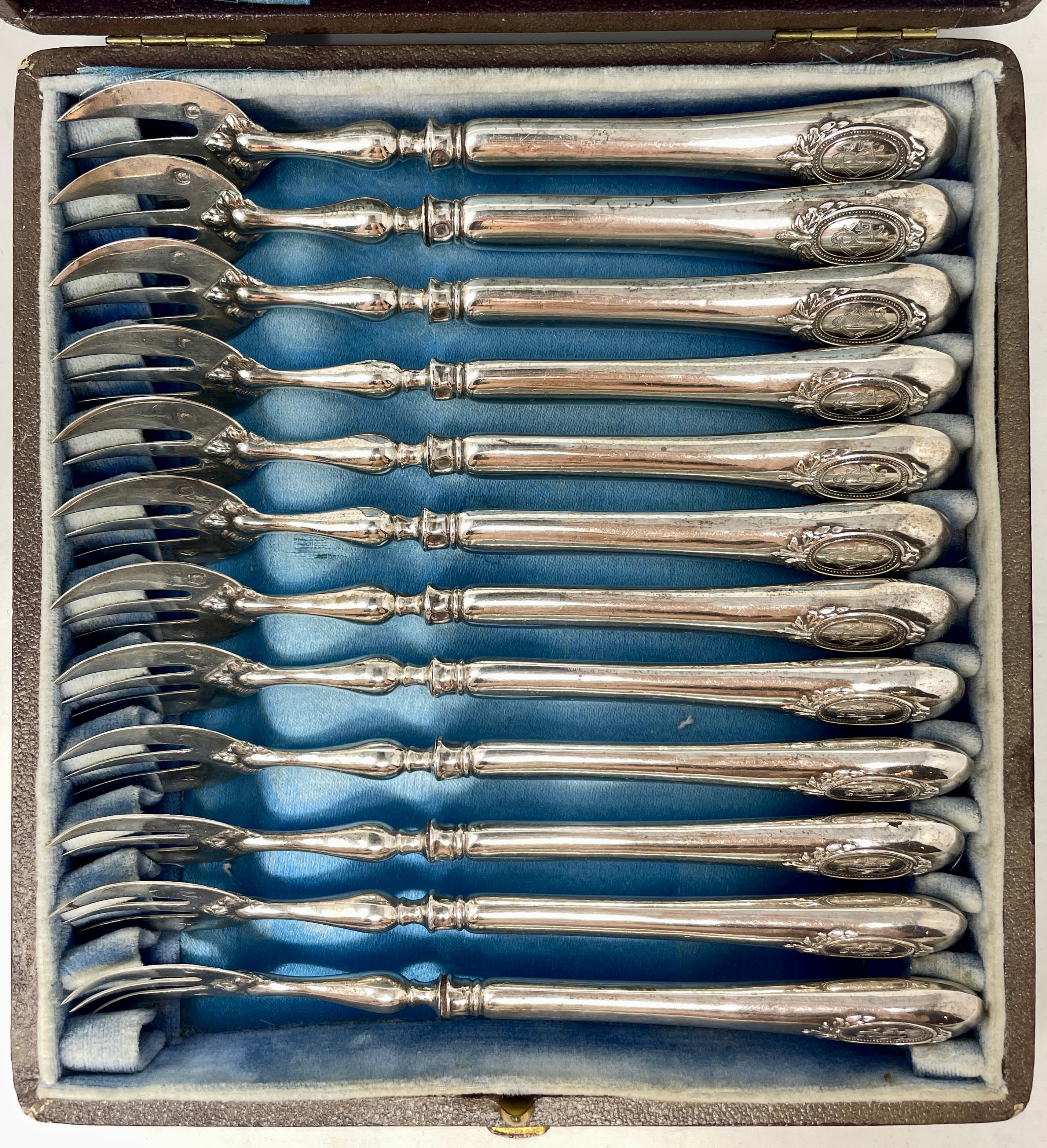 Set of 12 antique French silver hallmarked oyster forks in original case, circa 1885. 
Maker's mark: 