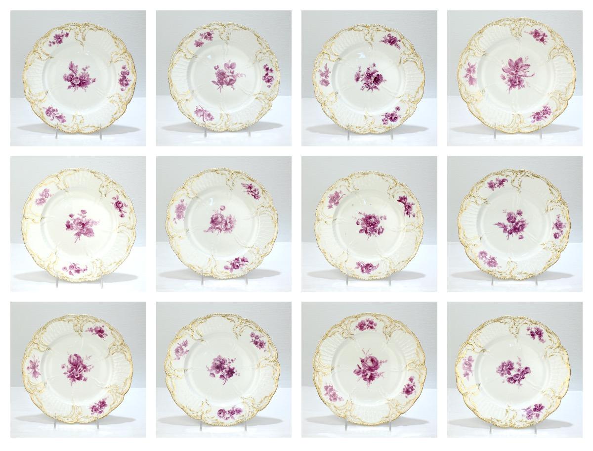 A very fine set of 12 antique porcelain dinner plates. 

Manufactured at K.P.M. Royal Berlin Porcelain Manufactory. 

In the Reliefzierat pattern with hand-painted floral sprays of puce-camaïeu flowers to the centers. 

This famous pattern was