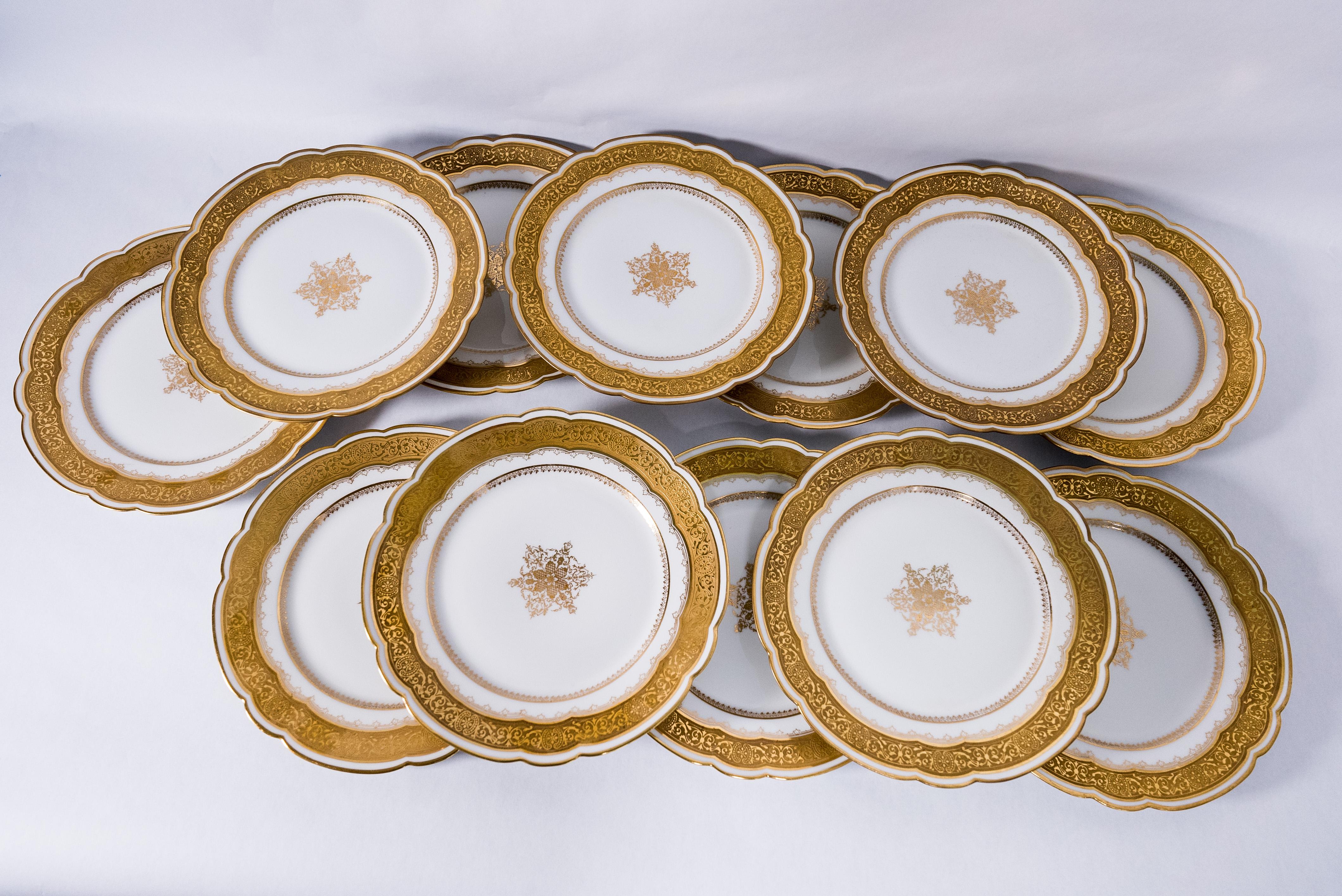 A lovely Circa 1890 set of dessert plates by the Limoges Factory M Redon. This group features a great scalloped shape to the plate with a nice detailed gilt surround band and a generous center medallion. They could also be used for luncheon or small