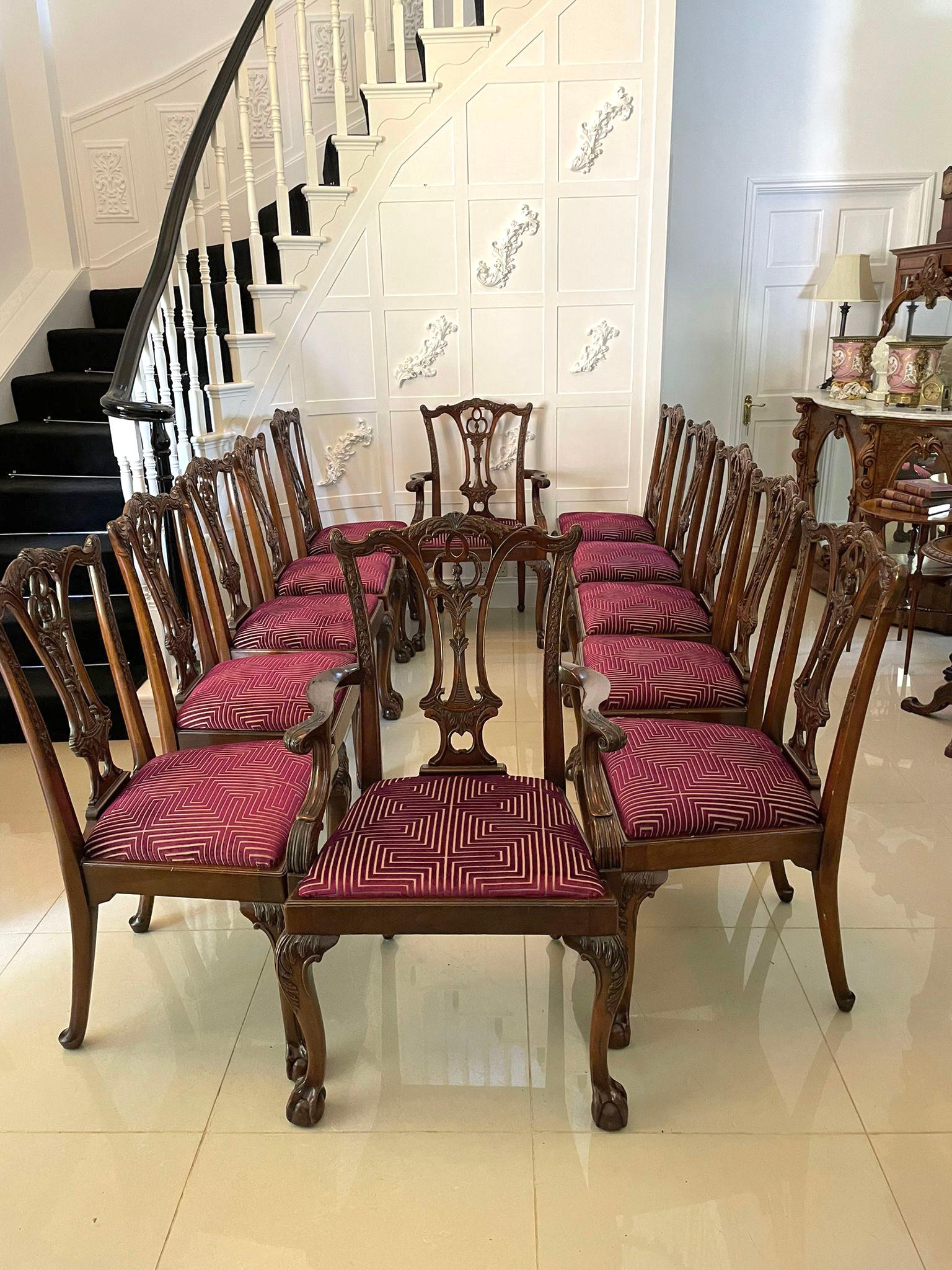 Set of 12 antique quality carved mahogany dining chairs consisting of 2 elbow chairs and 10 single chairs having a fantastic quality carved mahogany top rail with a pierced carved mahogany splat to the centre, newly reupholstered drop in seats in a