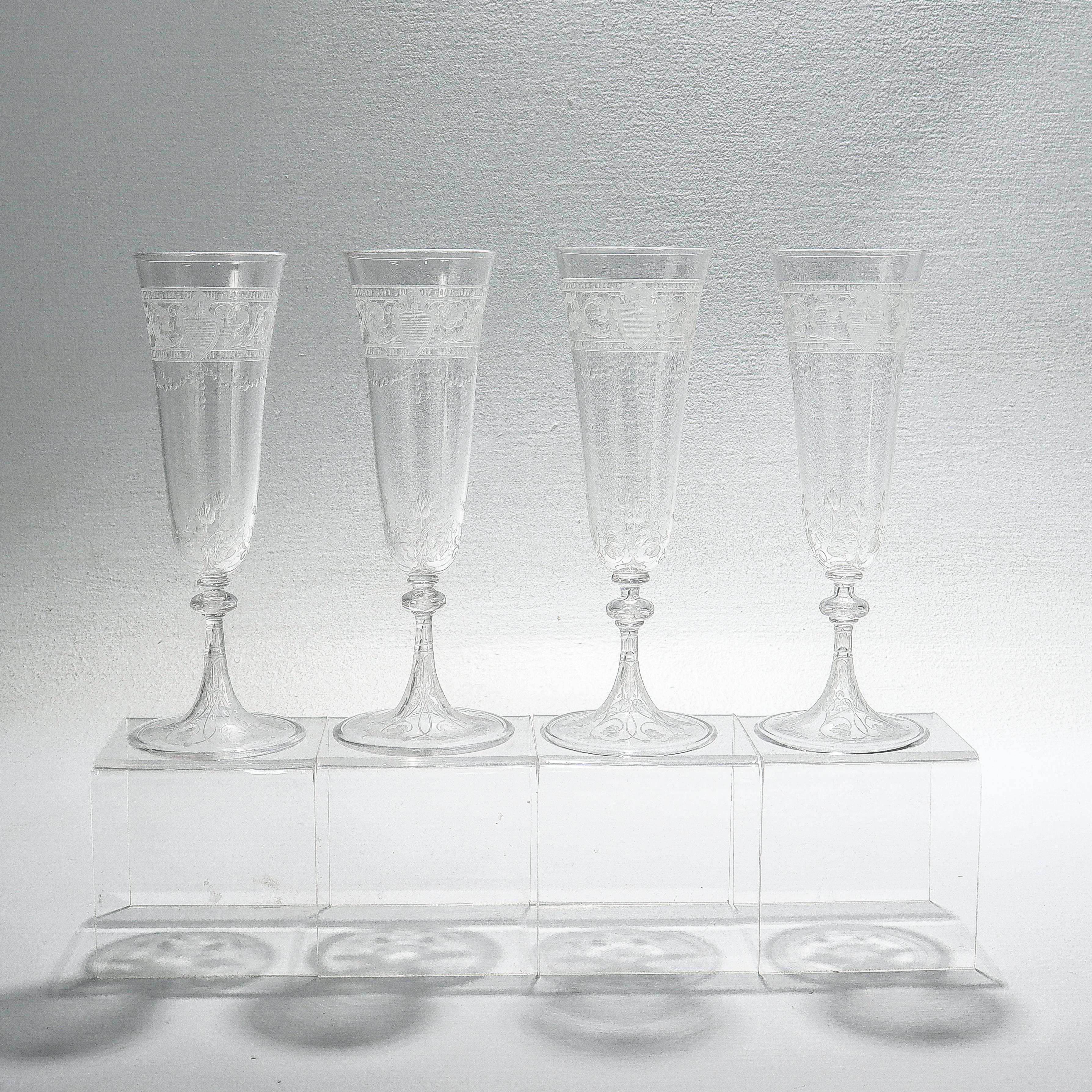 A fine set of 12 antique etched and engraved glass champagne flutes.

Attributed to Stevens & Williams or Webb.

With engraved & etched designs trelliswork, flowers, and shield devices.

Simply a wonderful set of English art glass