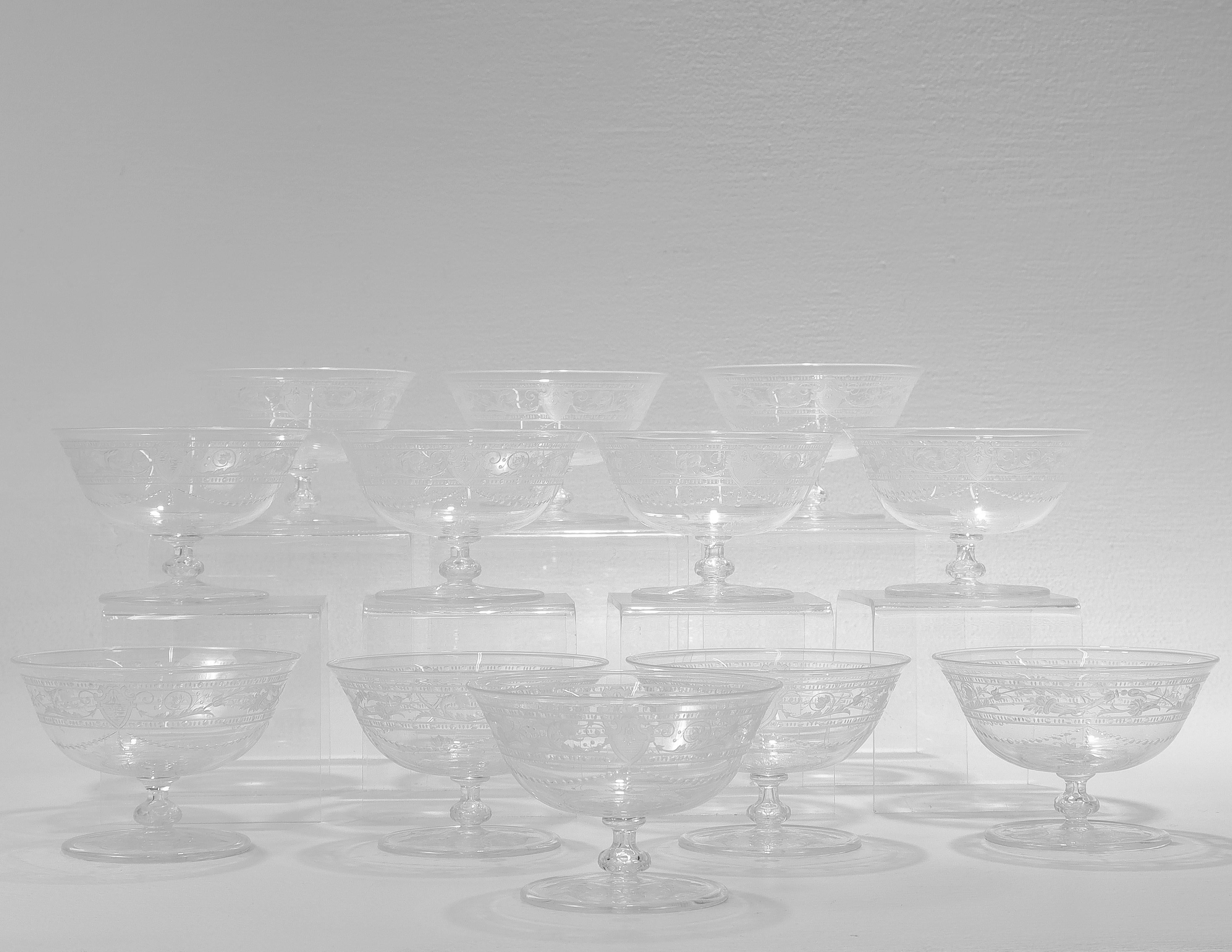 A fine set of 12 antique etched and engraved glass sherbert bowls.

Attributed to Stevens & Williams or Webb.

With engraved & etched designs trelliswork, flowers, and shield devices.

Simply a wonderful set of English art glass