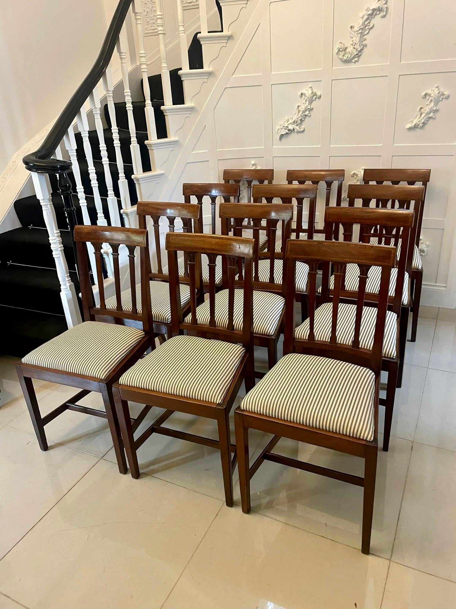 Set of 12 antique Victorian quality mahogany inlaid dining chairs having a quality mahogany top rail with satinwood inlay, carved mahogany splats to the centre of the back, newly reupholstered drop in seats in a quality fabric standing on elegant