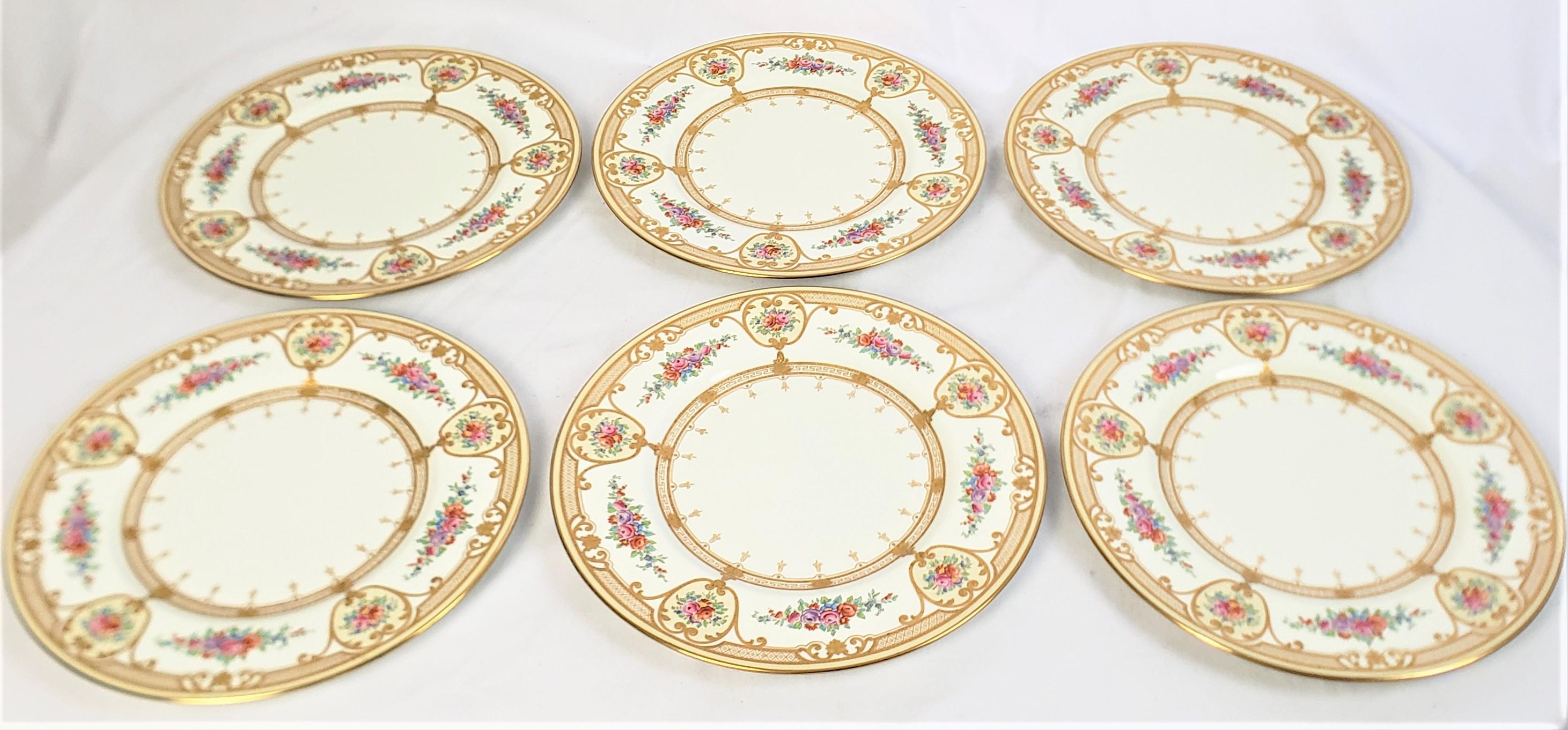 This set of twelve dinner plates were made by the well known Wedgewood factory of England in approximately 1900 in a Victorian style. The plates are composed of porcelain with a white ground with very ornately hand-painted bouquets of Spring flowers