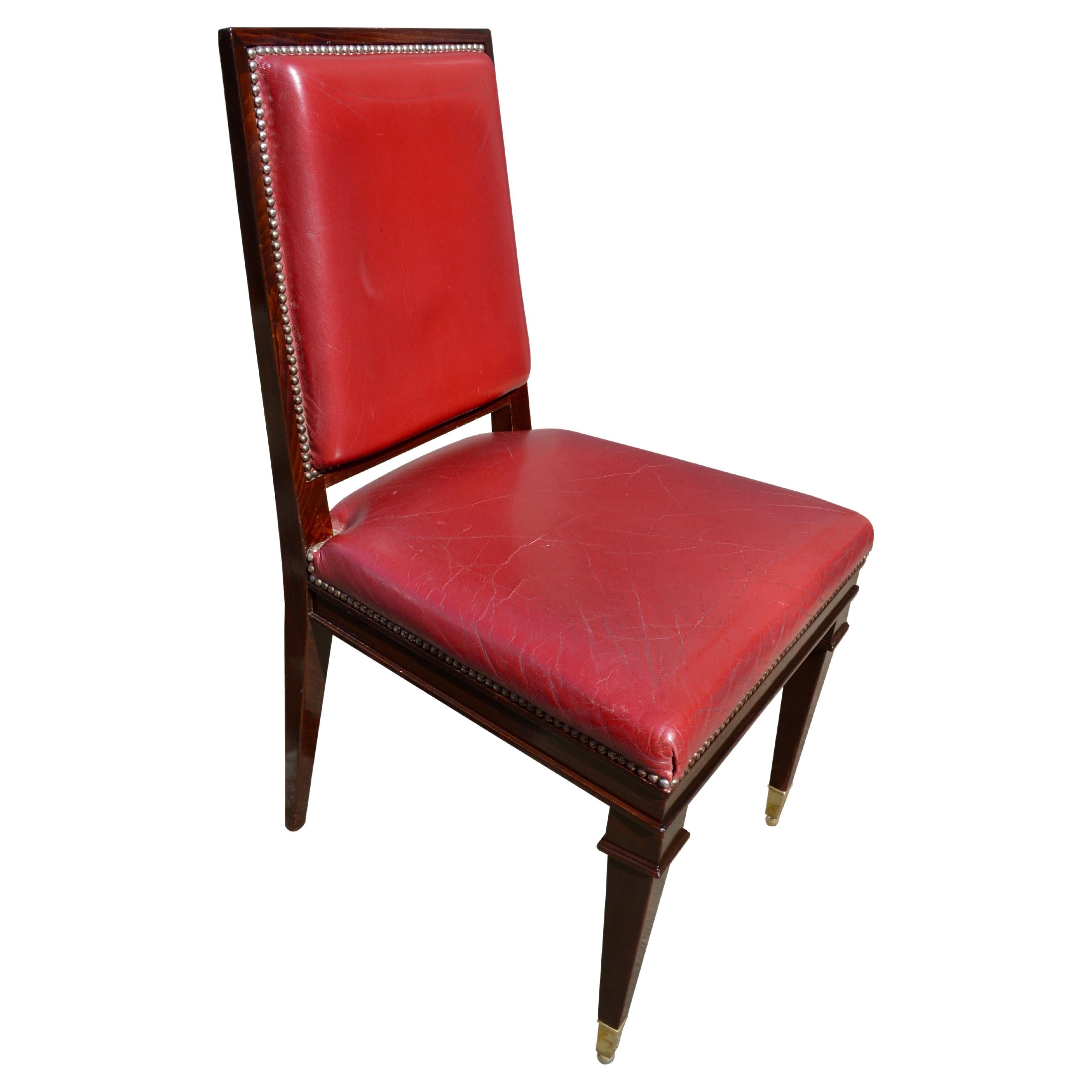 The frames of these Classic Art Deco dining chairs are of stained beech to resemble palisander or macassar ebony. The rectangular shaped seats and backs are upholstered in red leather with brass nailing all of which are in very good condition; the