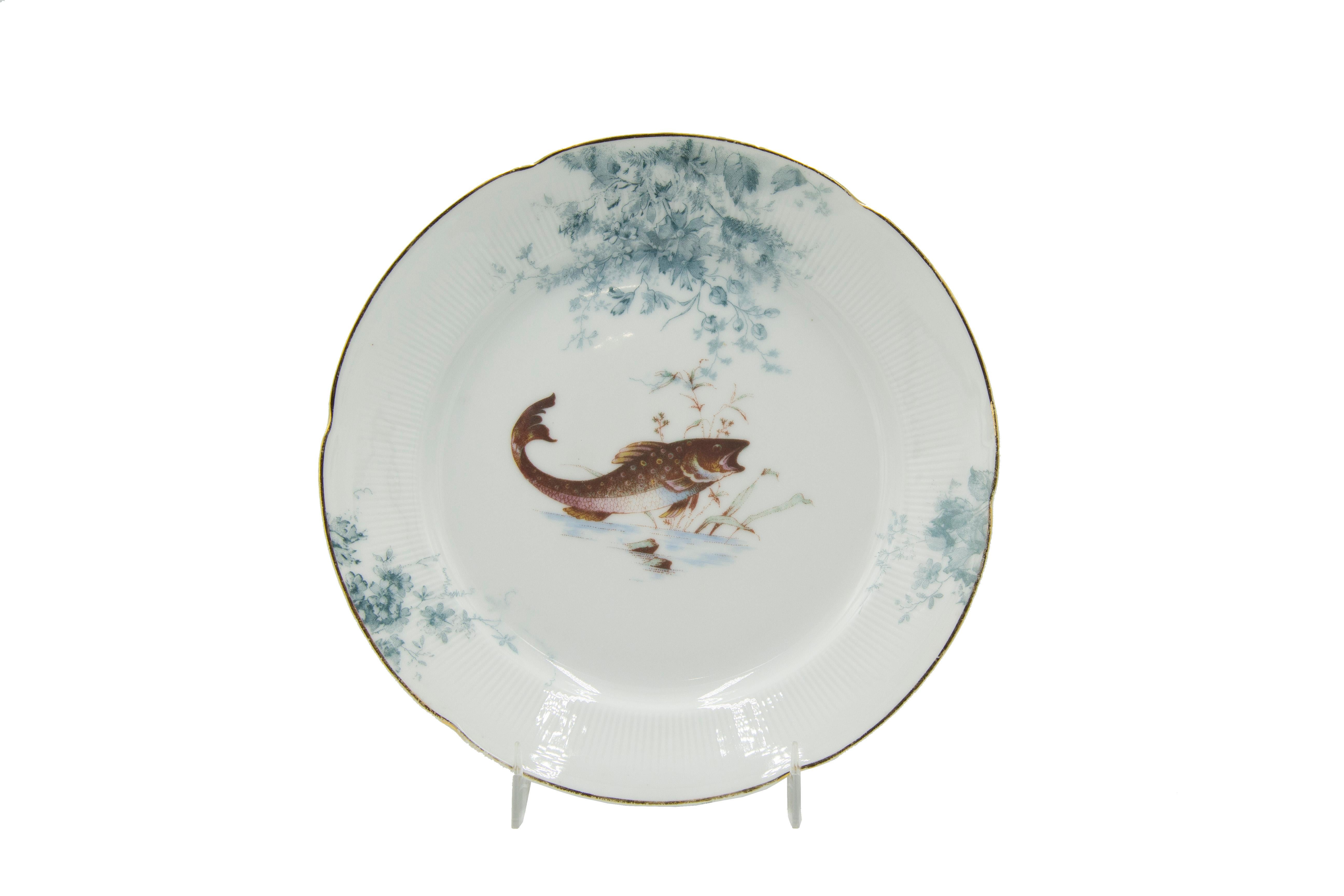 Set of 12 Austrian (19th Century) white and grey porcelain plates with floral design and fish at center (PRICED AS SET).
 