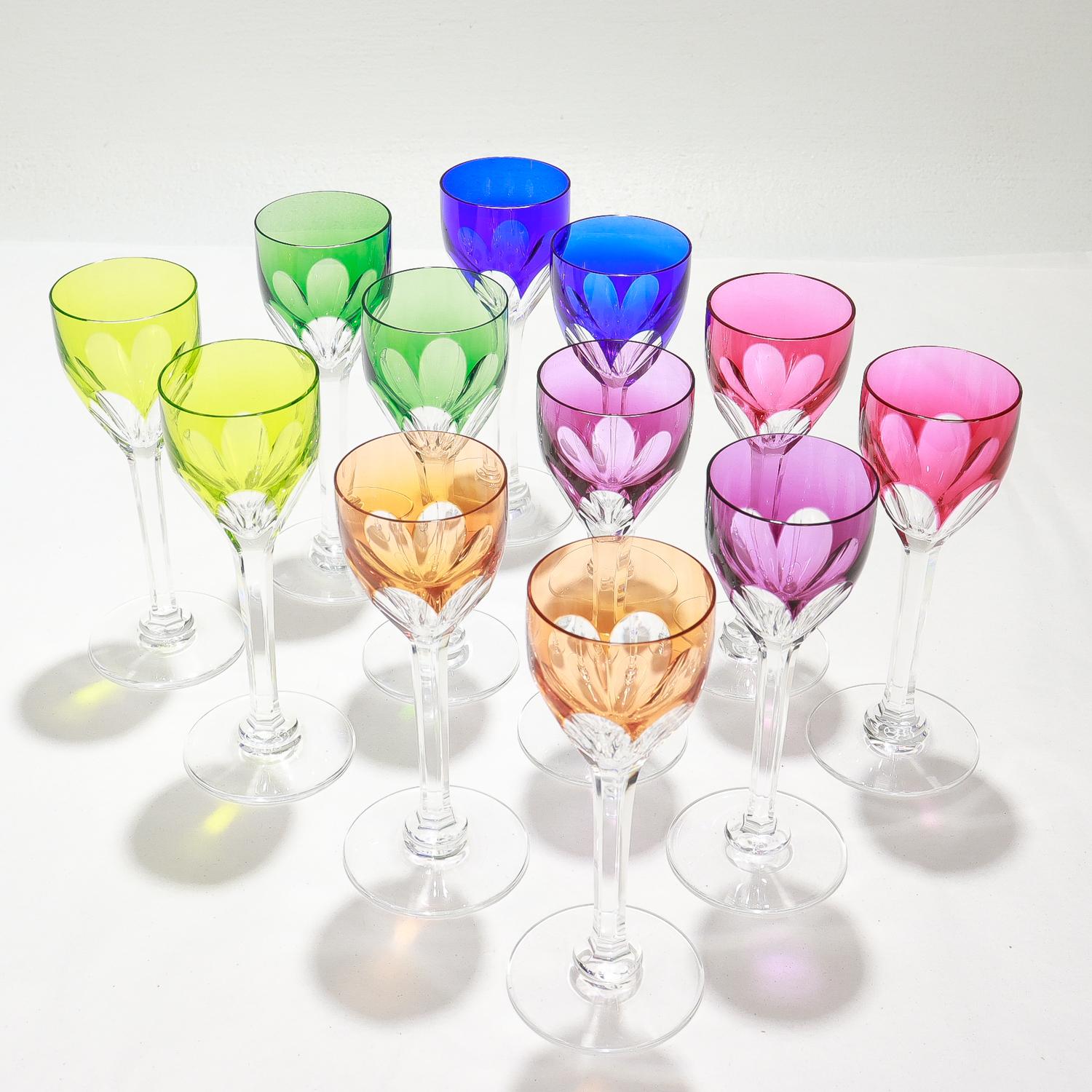 A fine set of 12 wine glass cordials.

By Baccarat.

In the Harcourt pattern.

The set of 12 has 6 pairs of cordials the primary and secondary colors (red, blue yellow, green, purple, orange) on cut-to-clear glass.

Marked with an acid-etched
