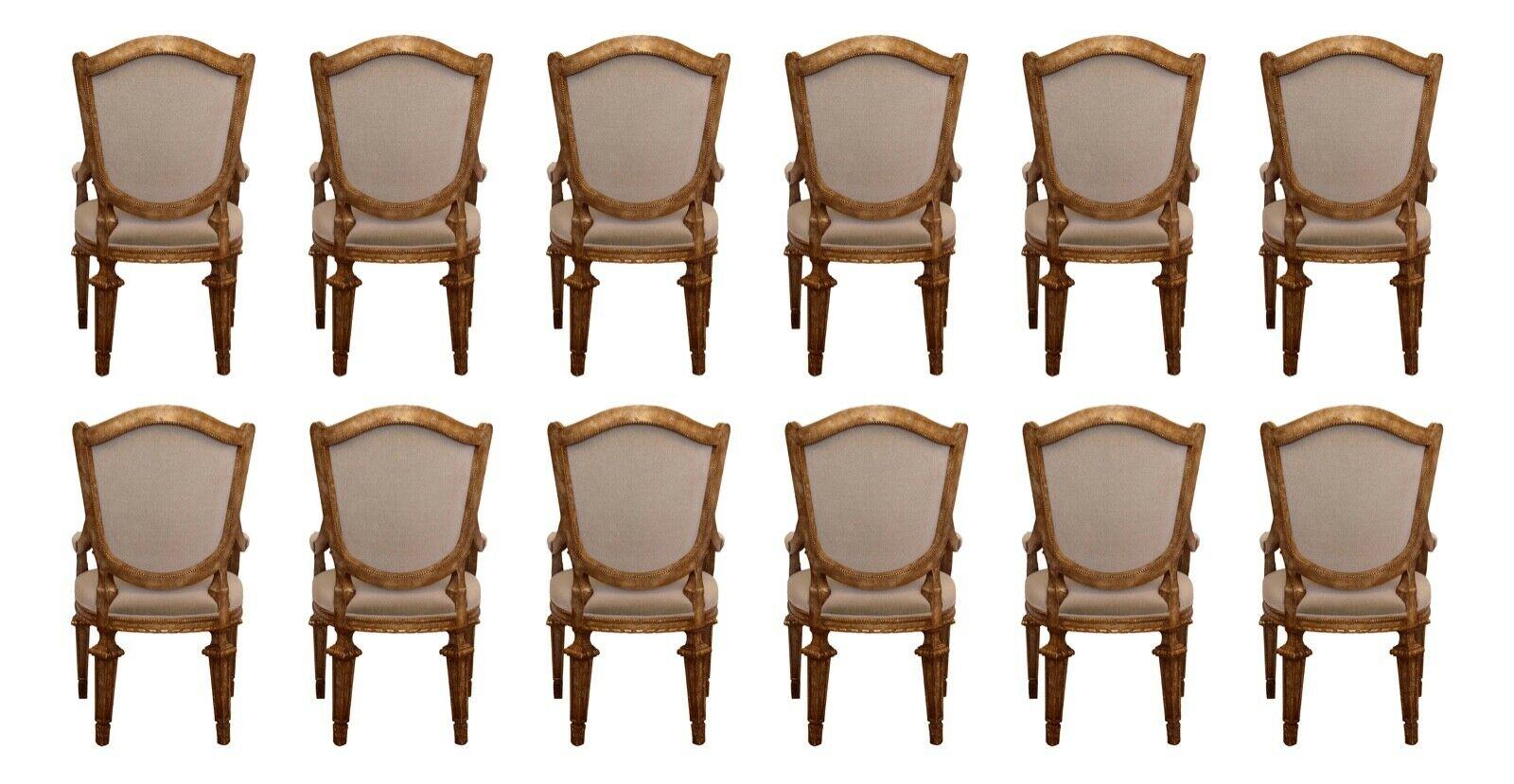 This lovely set of 12 armchairs by Baker are detailed in an antique gold frame and neutral grey upholstered seats and backs. In very good condition.

Dimensions: 24.5 W X 28 D X 42 H; seat height: 20.5