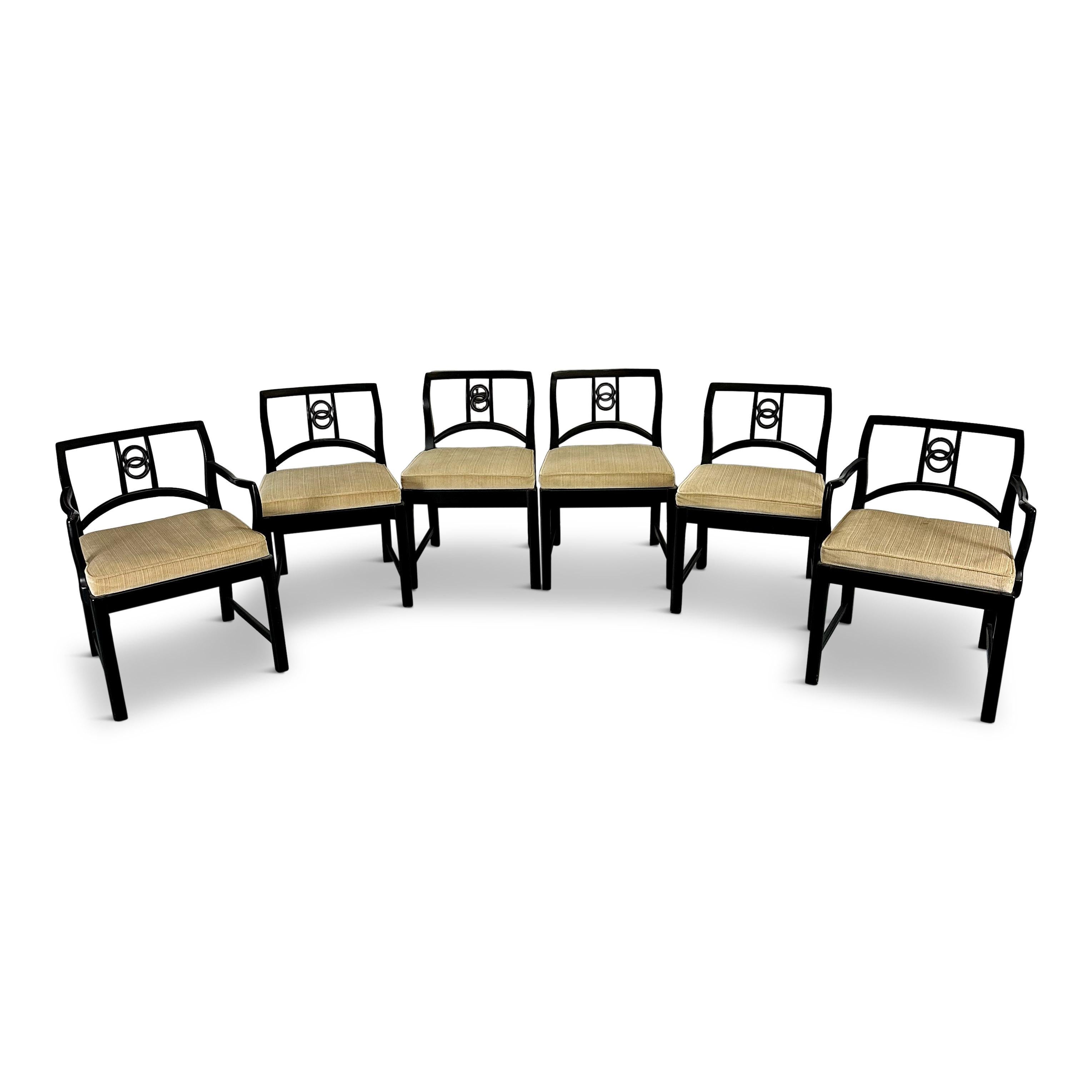 Sophisticated and elegant set of mid-century modern sculptural dining chairs designed by the American design legend Michael Taylor for Baker Furniture, circa 1960s. The set includes 4 arm and 12 side chairs. This particular series is one of the most