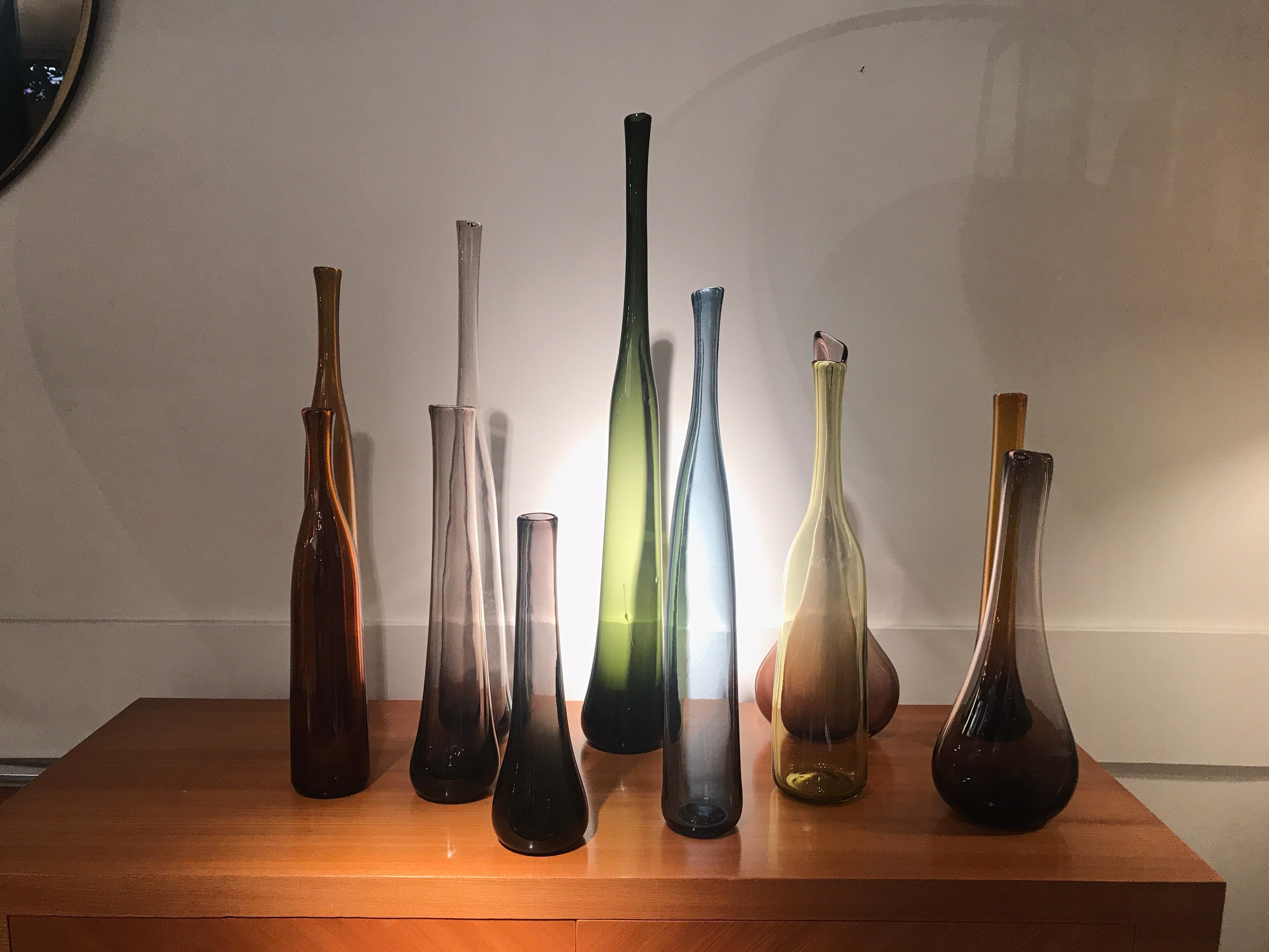 12 bottles in glass blown by The French artist Claude Morin, atelier Dieufit France
Most are signed Morin and dated circa 1971
All are in different colors and Forms.
Sold as a set.
 