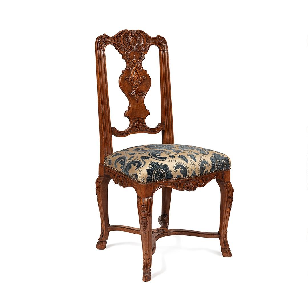 A stunning set of 12  dining chairs regence style , probably a special order because suites of 12 chairs are rare
the are covered with fabrics of this period which is in very good condition,the work of the sculpture in the backrest is finely