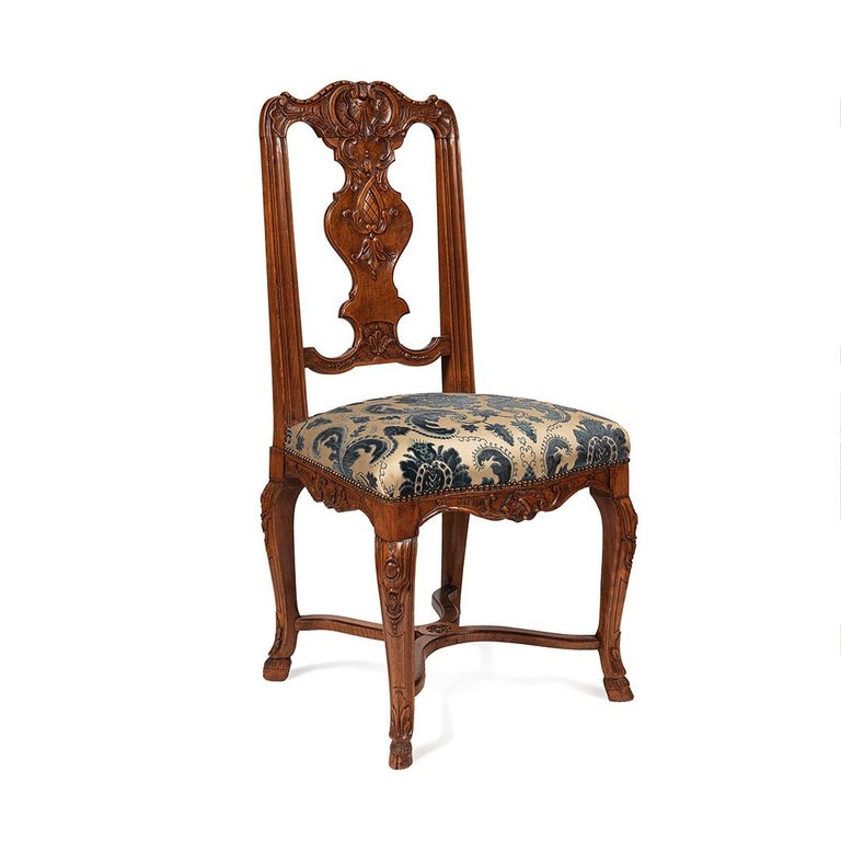 A stunning set of 12  dining chairs regence style , probably a special order because suites of 12 chairs are rare
the are covered with fabrics of this period which is in very good condition,the work of the sculpture in the backrest is finely