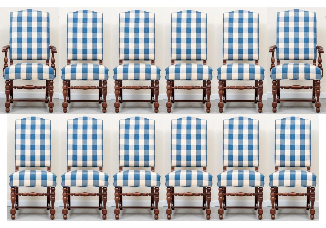 Set of 12 Charles Stewart dining room chairs comprised of 2 armchairs and 10 side chairs. The chairs with off-white and blue tonal plaid upholstery having a slight nubby texture are impeccably piped around the backrest and seat. The chairs with an