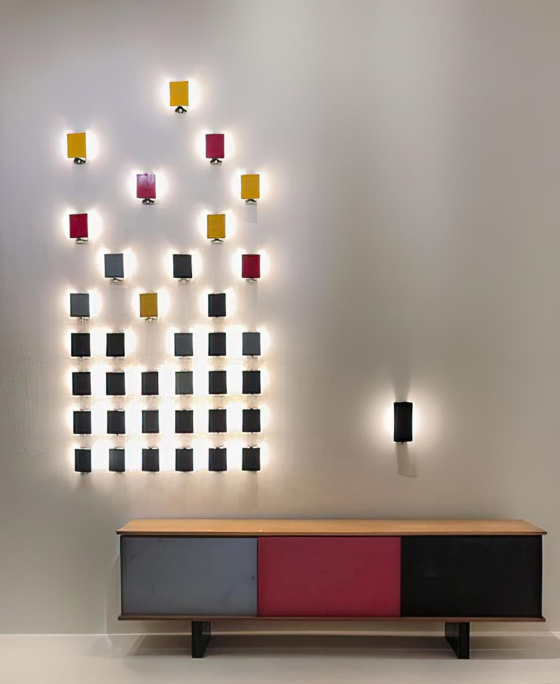 Set of 12 Charlotte Perriand 'CP1' wall lights. A clean and iconic design executed in red (RAL 3002), black, blue (RAL 5002) and white painted metal. 

Price is for the set. Two sets available. 

In-stock lead time up to 2-3 weeks. Out of stock lead
