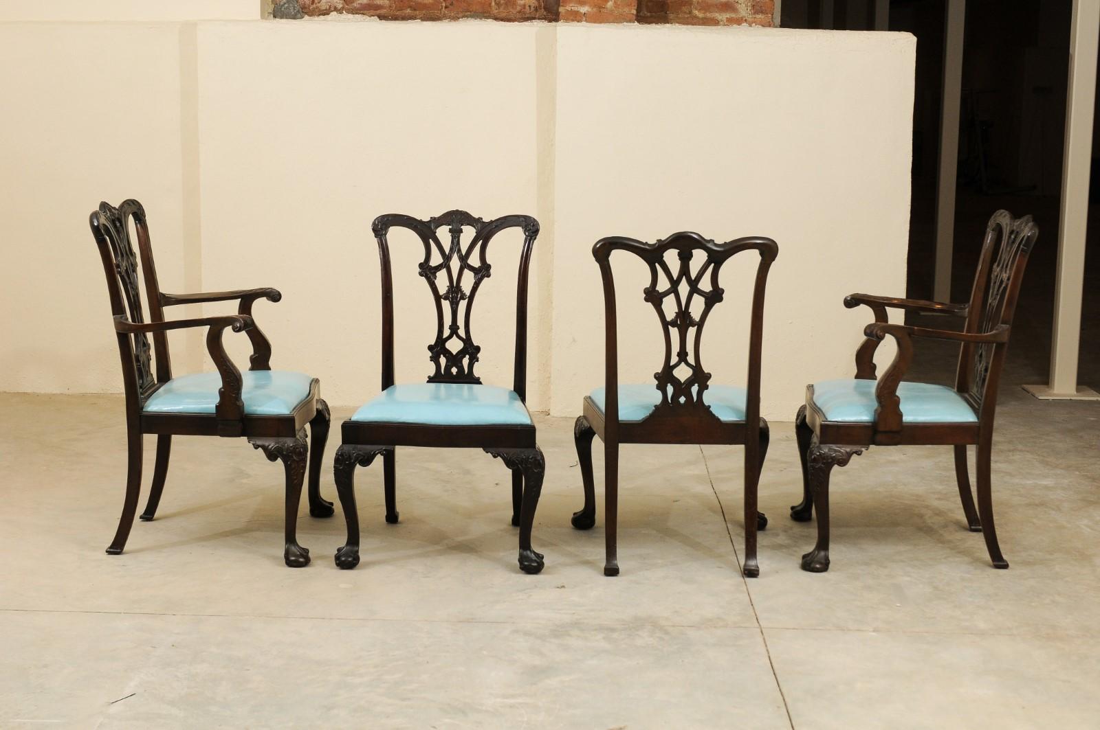 The Chippendale style mahogany dining chairs with 2 arm chairs and 10 side chairs featuring pierced black splats, removable light blue leather seats and carved cabriole legs with ball and claw feet. 

Arms dimensions are 41