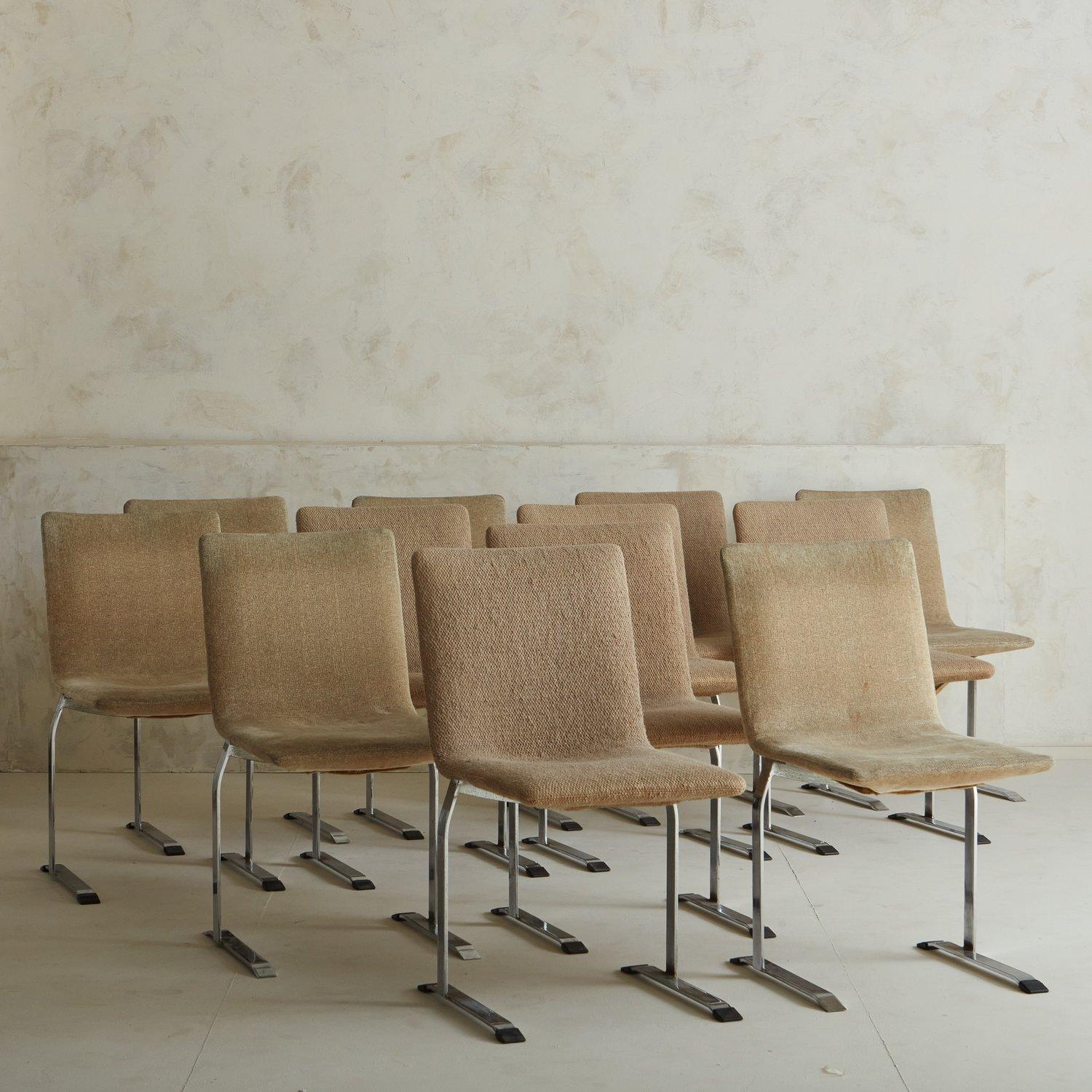 A set of 12 dining chairs designed by Giovanni Offredi for Saporiti, Italy in the 1970s. These chairs have chrome metal frames with curved seats in original taupe upholstery. Retains ‘Saporiti Italia’ stickers on metal base.

Giovanni Offredi