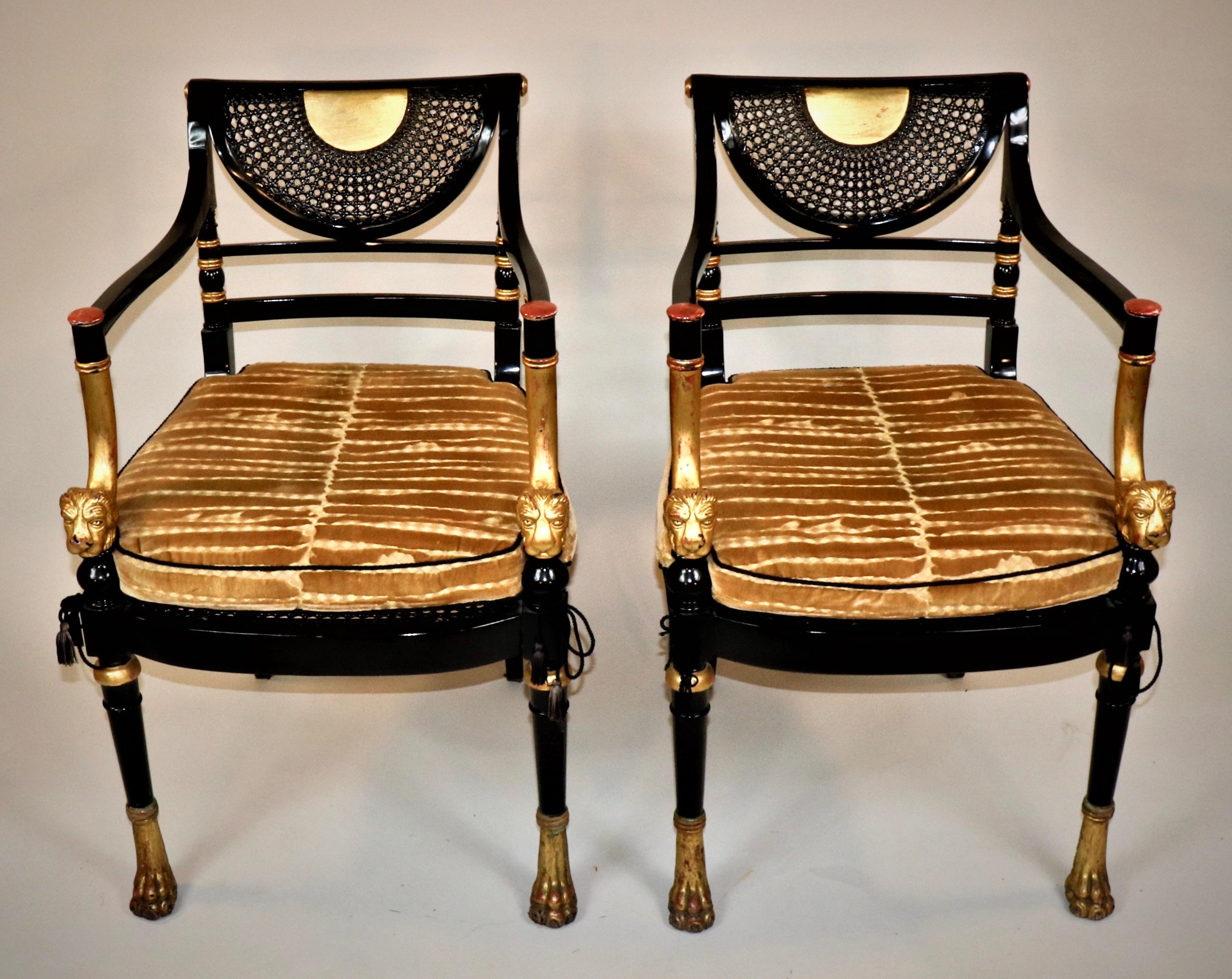 This marvelous set of 12 Circa 1910 Empire style black lacquered and gilded chairs consists of two armchairs and ten regular side chairs. The backs have intricate fans of cane work with gold accents for vibrancy. The caned seats have also been