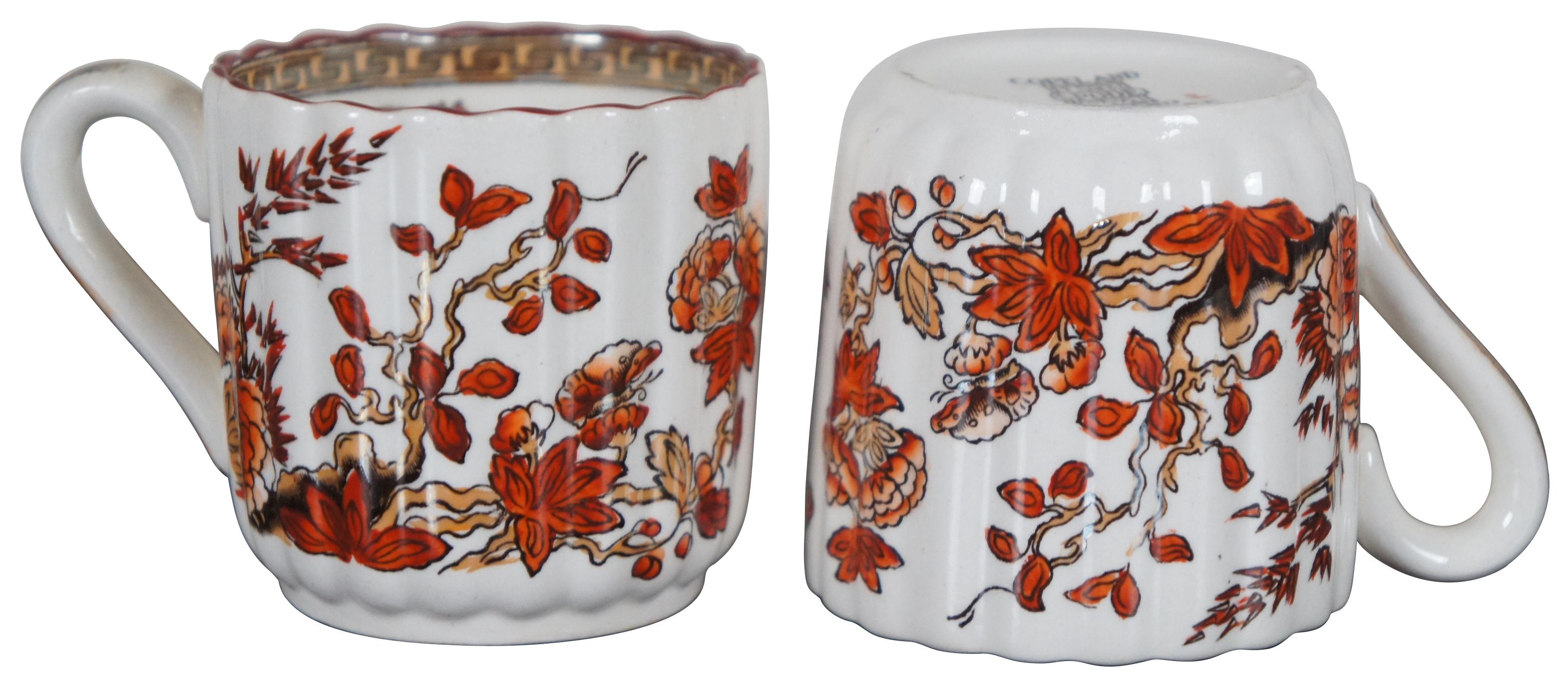 Set of twelve vintage Copeland Spode demitasse coffee cups in the India Tree pattern, featuring red-orange floral branches and Greek key accents.
       