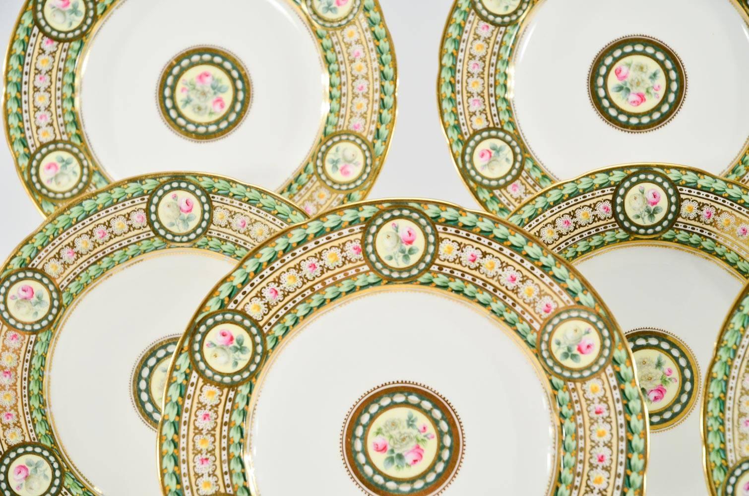 This set of 12 Copeland dessert plates features hand painted rose decoration in a perfect palette of greens, pinks and yellows. Framed in a gold border, surrounded by lush leaves and 6 reserves of roses surrounding the perimeter these make superb