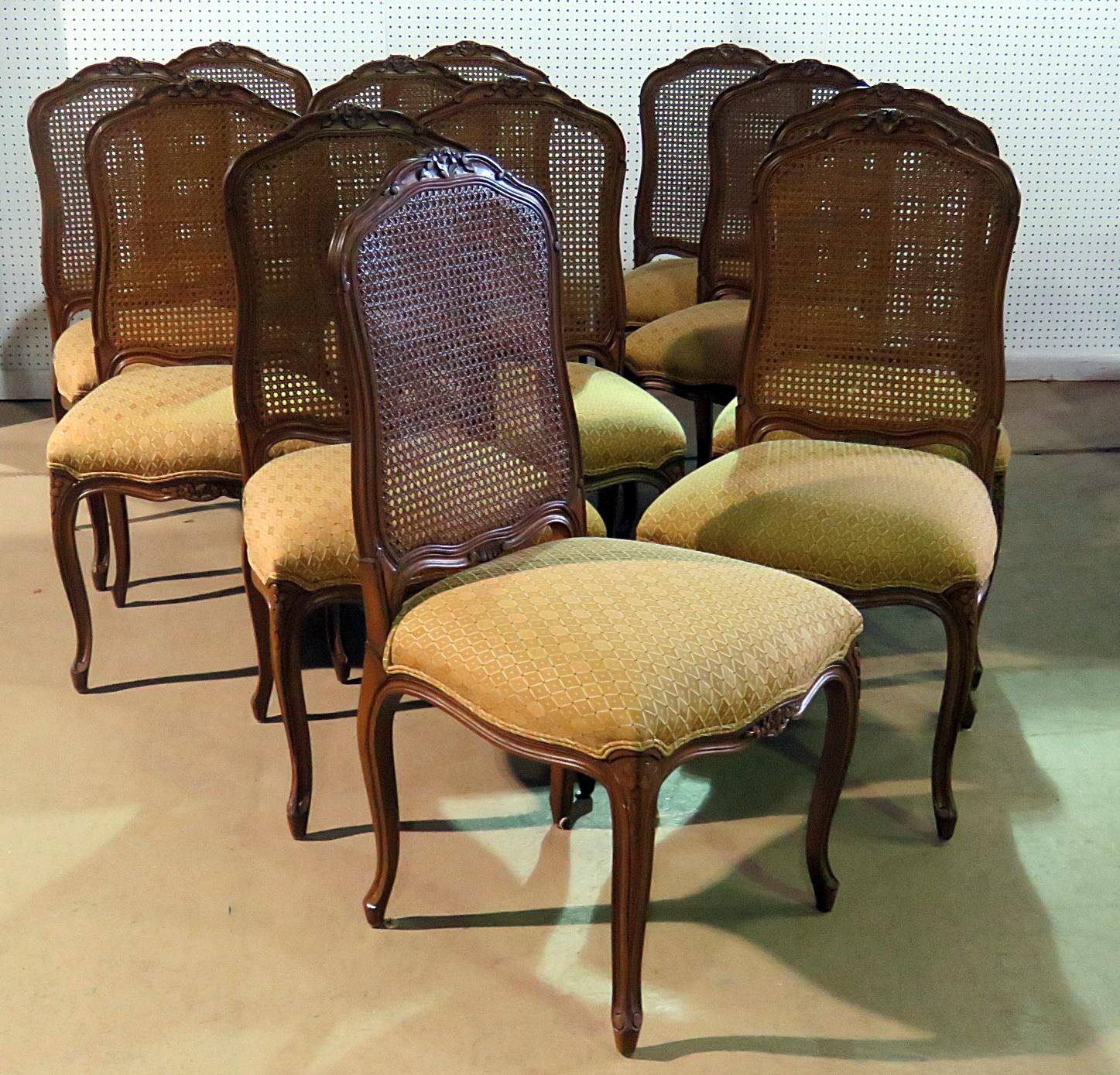 This is a superb set of 12 cane back Louis XV chairs. This Set of 12 country French dining side chairs features caned backs and beautiful carved legs and simple lines.