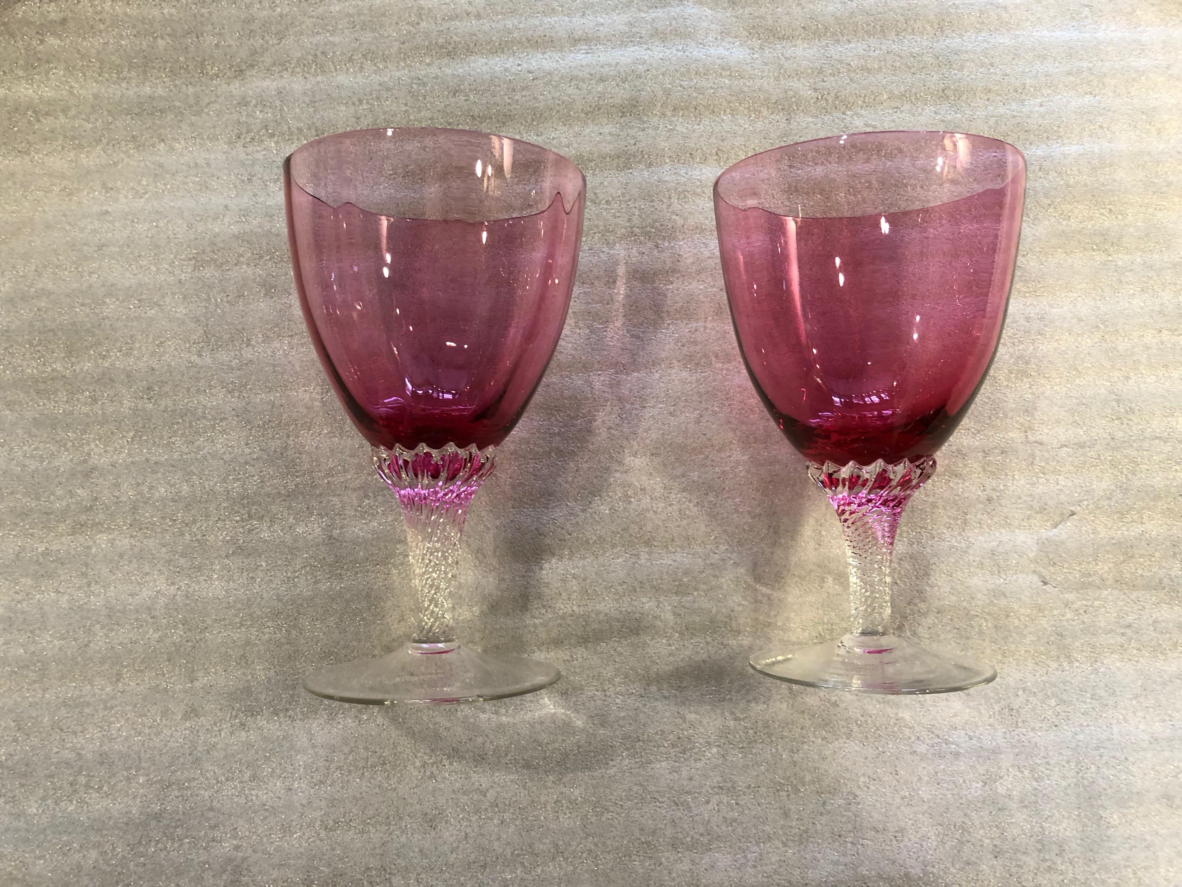 This set of cranberry glasses have a clear twisted stem.