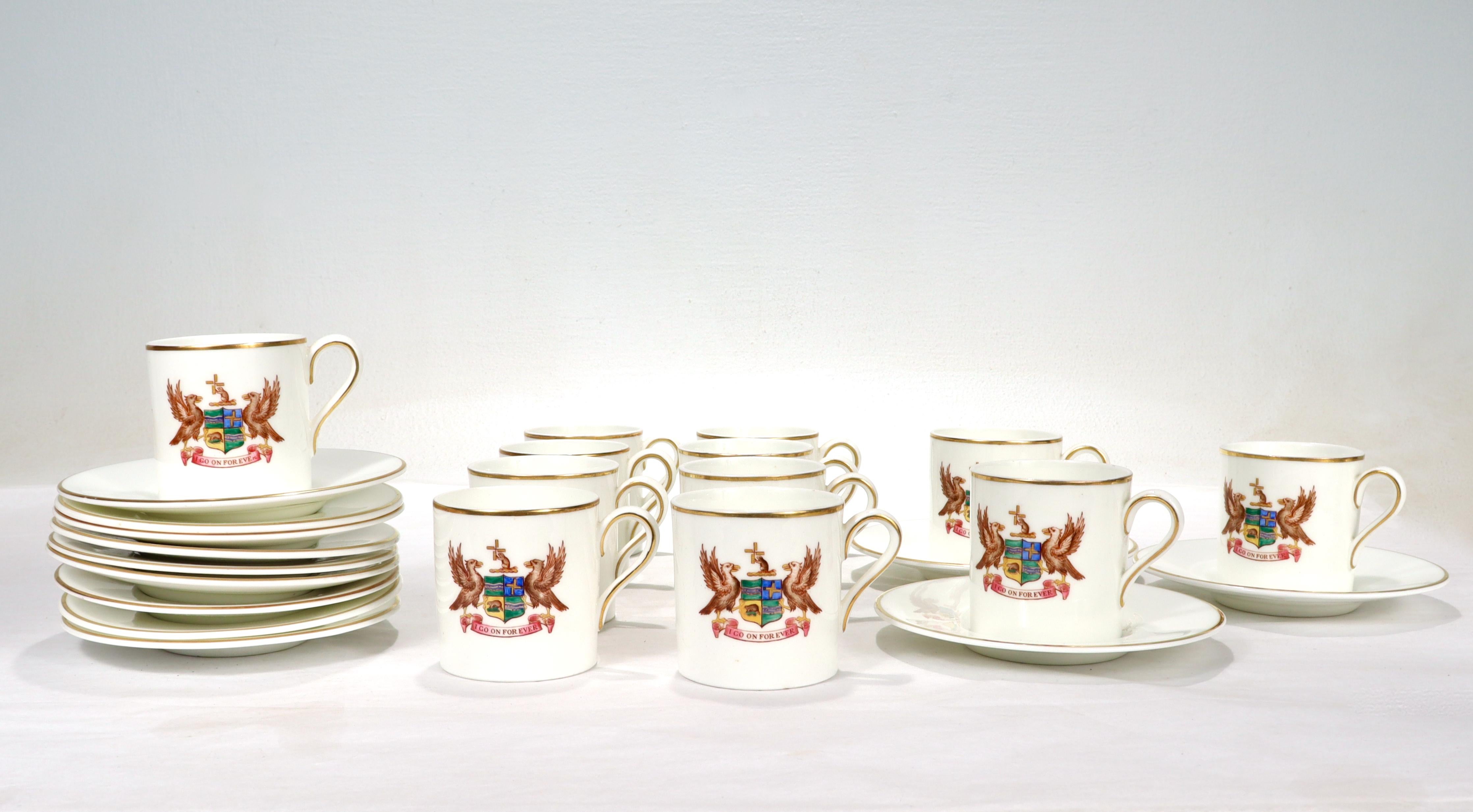 A fine set of 12 bone china cups & saucers. 

By Wedgwood.

Each cup is decorated with the crest of The Brook, a New York City private gentleman's club founded in 1903. 

Below the crest is the club motto of: 