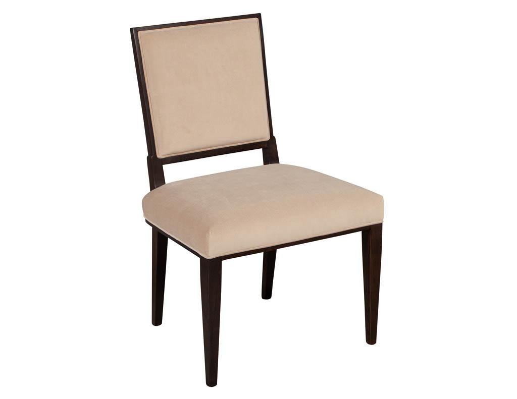 Set of 12 custom modern walnut dining chairs. Solid walnut modern designed dining chairs upholstered in a taupe velvet with a geometric designer outside back fabric. Set includes 10 side chairs and 2 arm chairs

Price includes complimentary curb